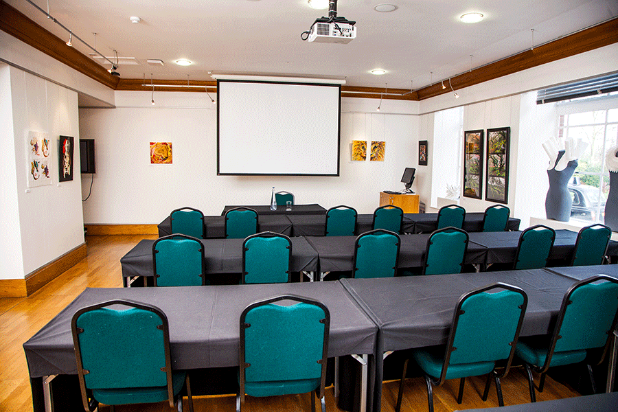 Knapp Gallery meeting space with teal chairs, ideal for corporate events and workshops.