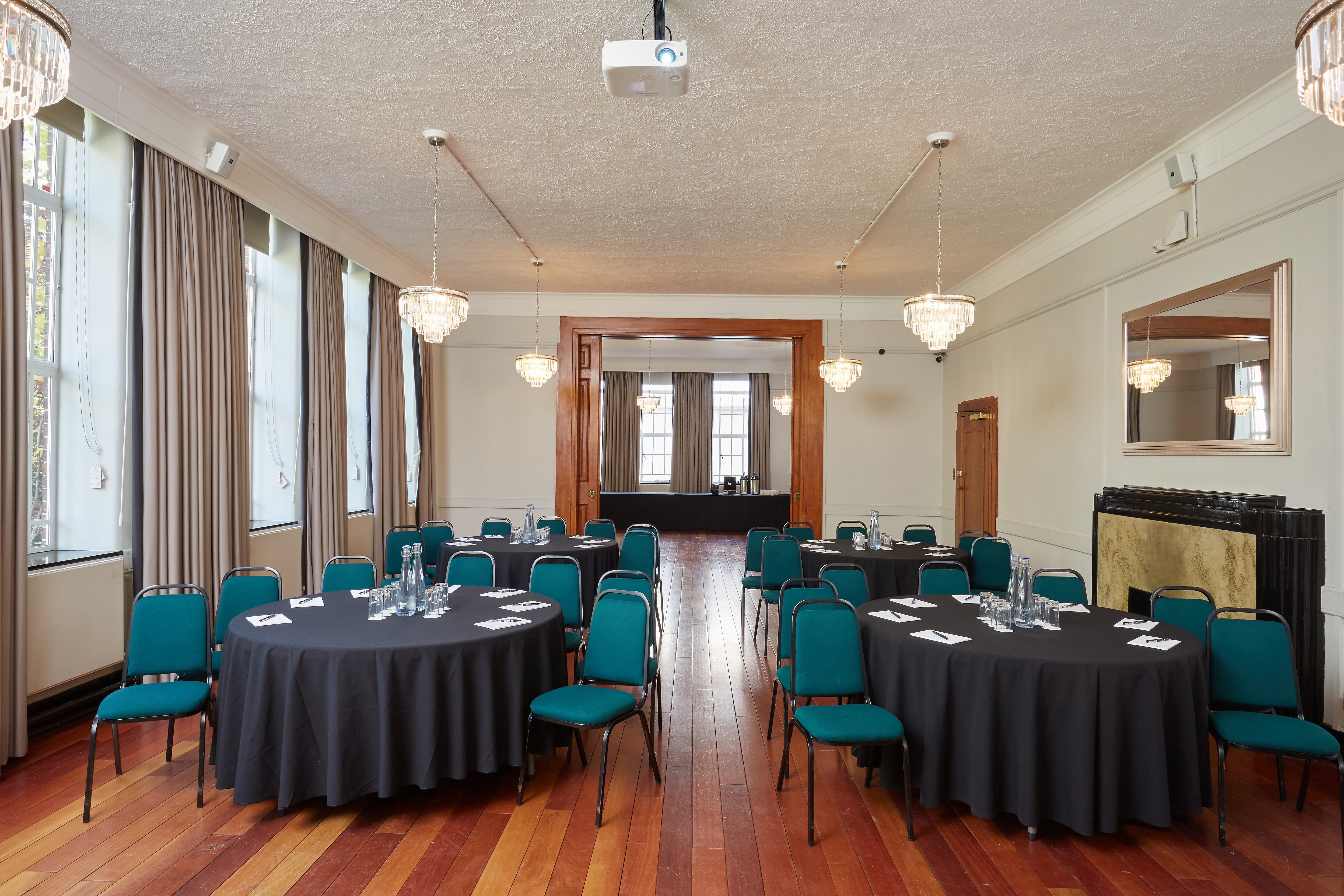 Tuke Common Room: elegant event space with round tables, ideal for meetings and conferences.