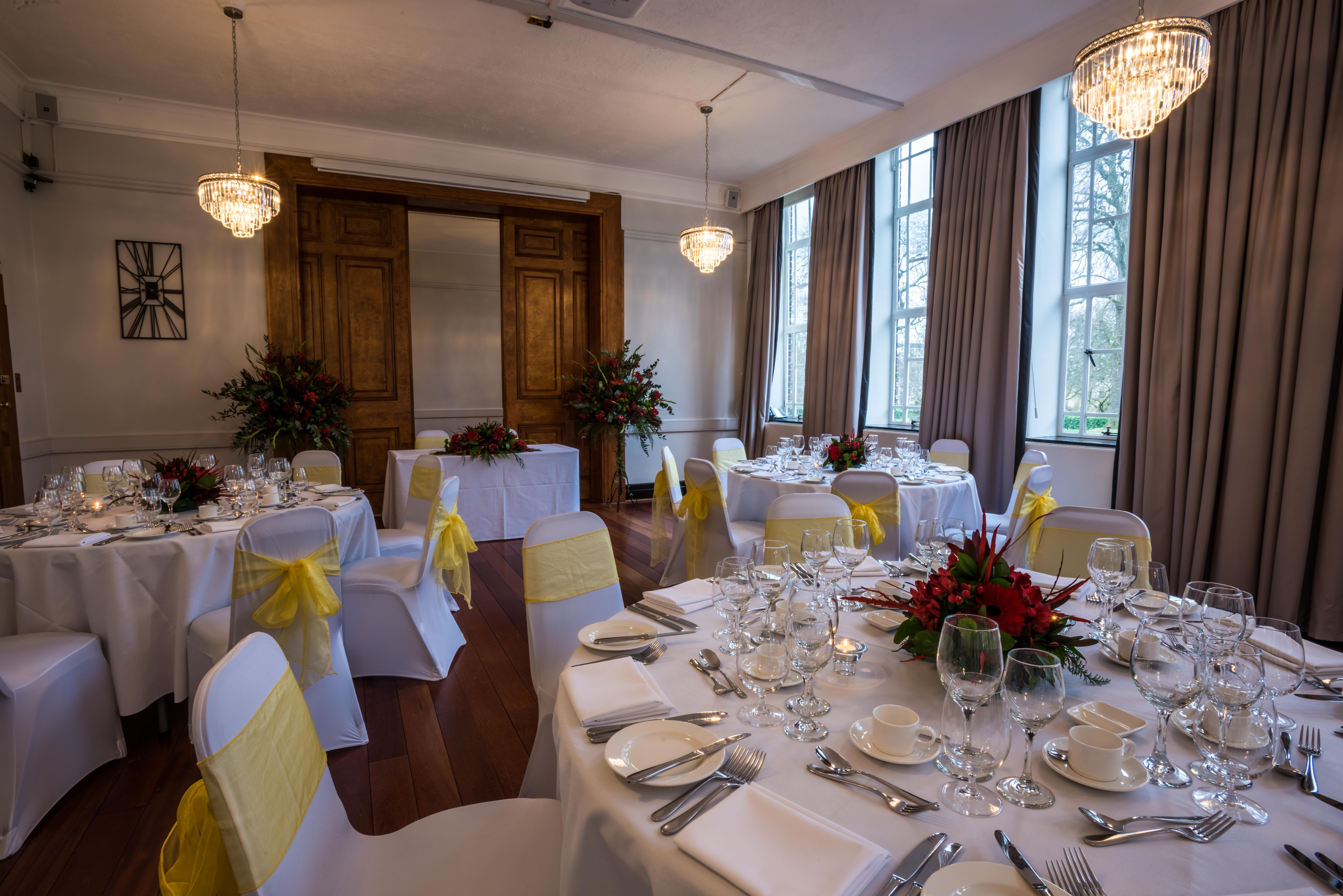 Elegant Tuke Common Room with round tables, ideal for weddings and corporate events.