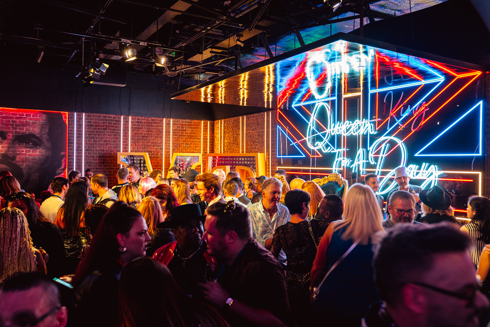 Vibrant networking event at Madame Tussauds with colorful neon lighting.
