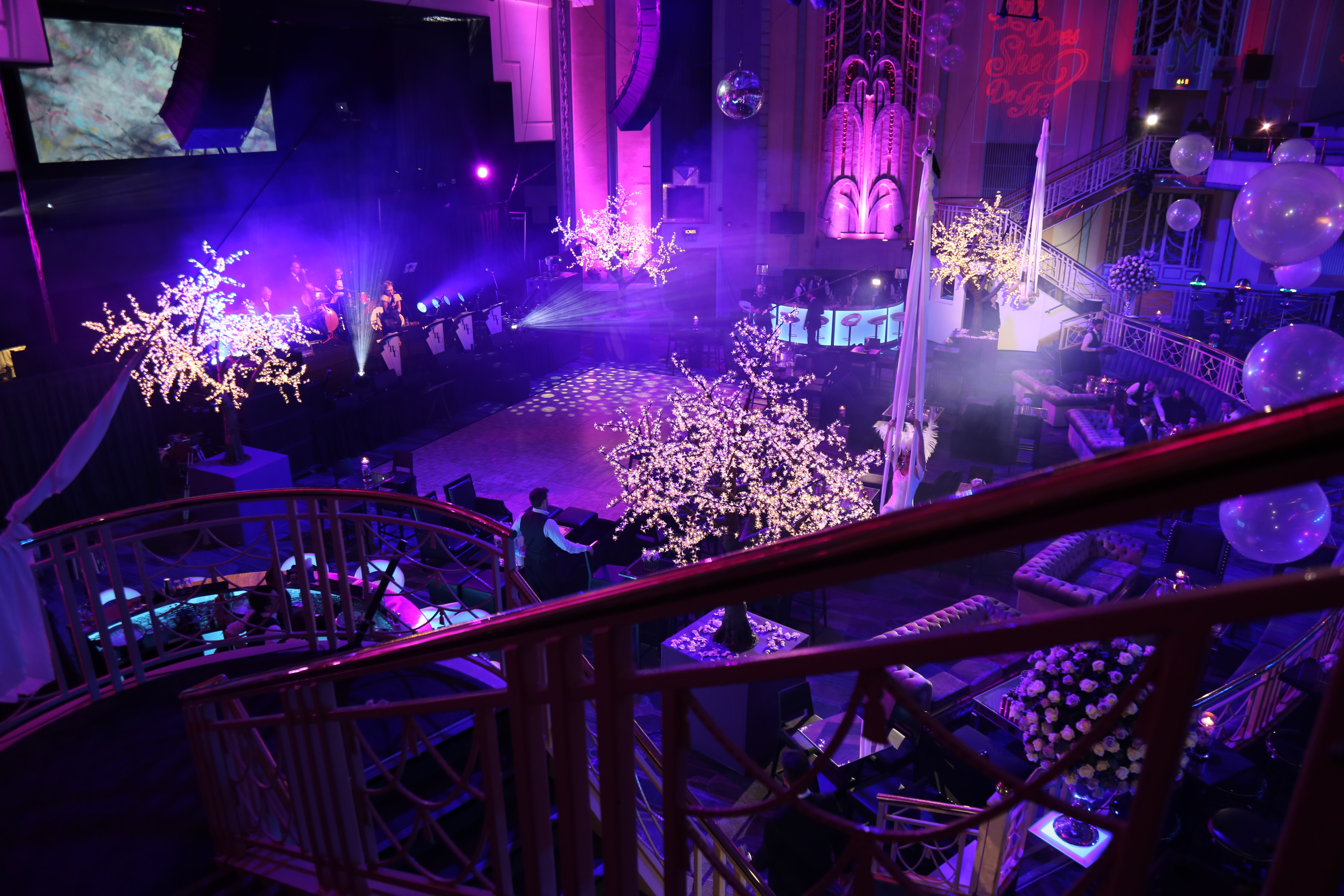 Christmas party at Troxy with elegant decor and illuminated trees for festive networking.