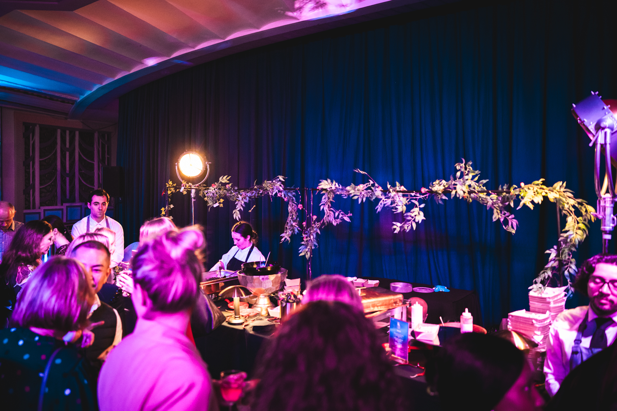 Christmas party at Troxy with vibrant food station and warm lighting for networking.