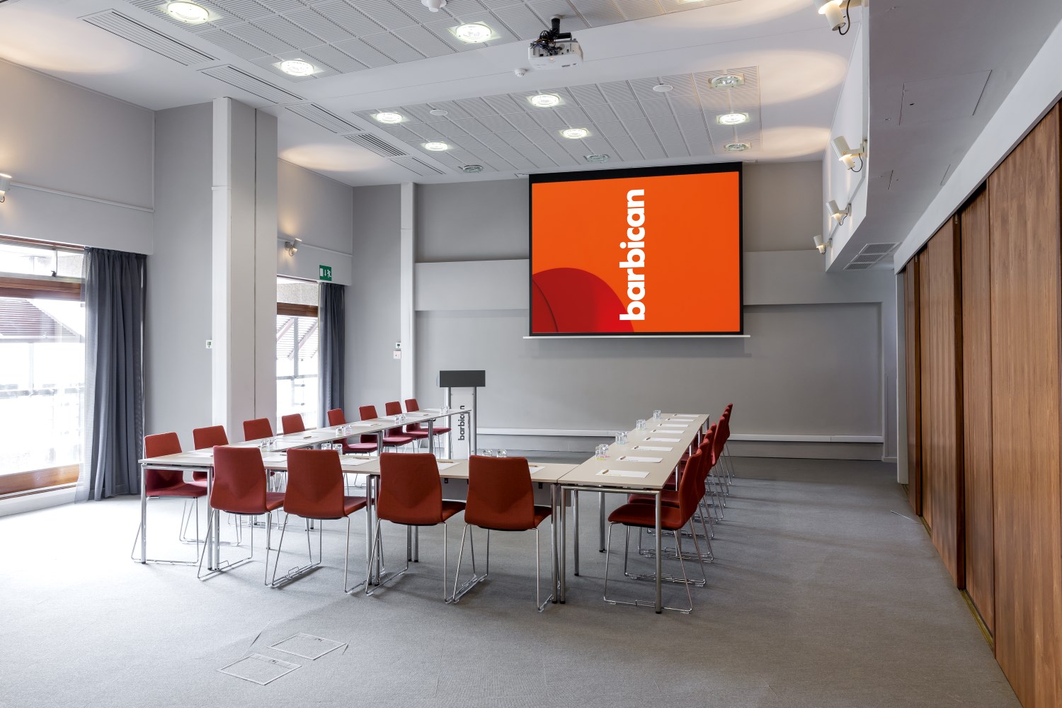 Modern meeting room at Barbican Centre with U-shaped table for corporate events.