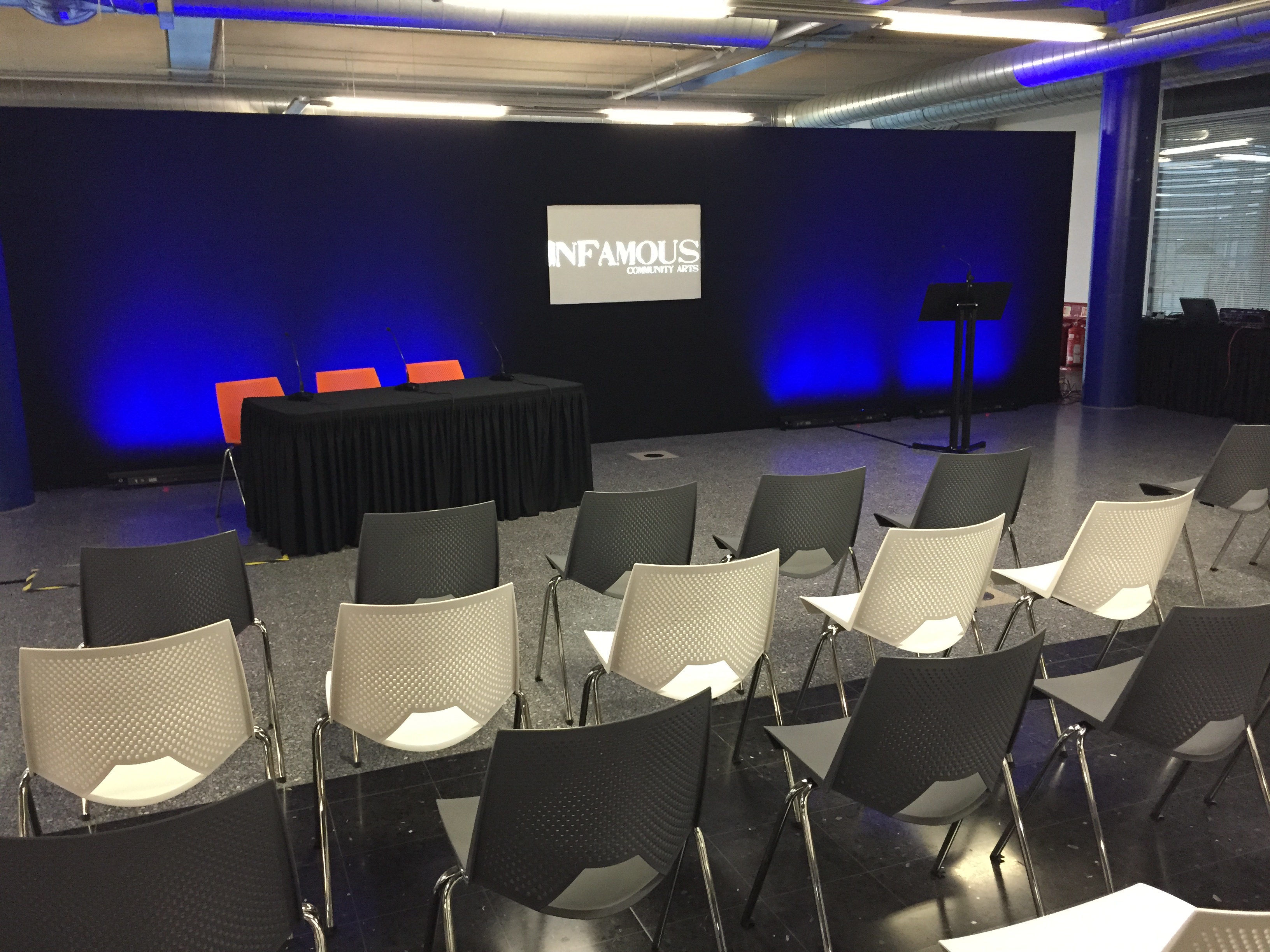 Event space at Millennium Point with sleek stage setup for presentations and discussions.