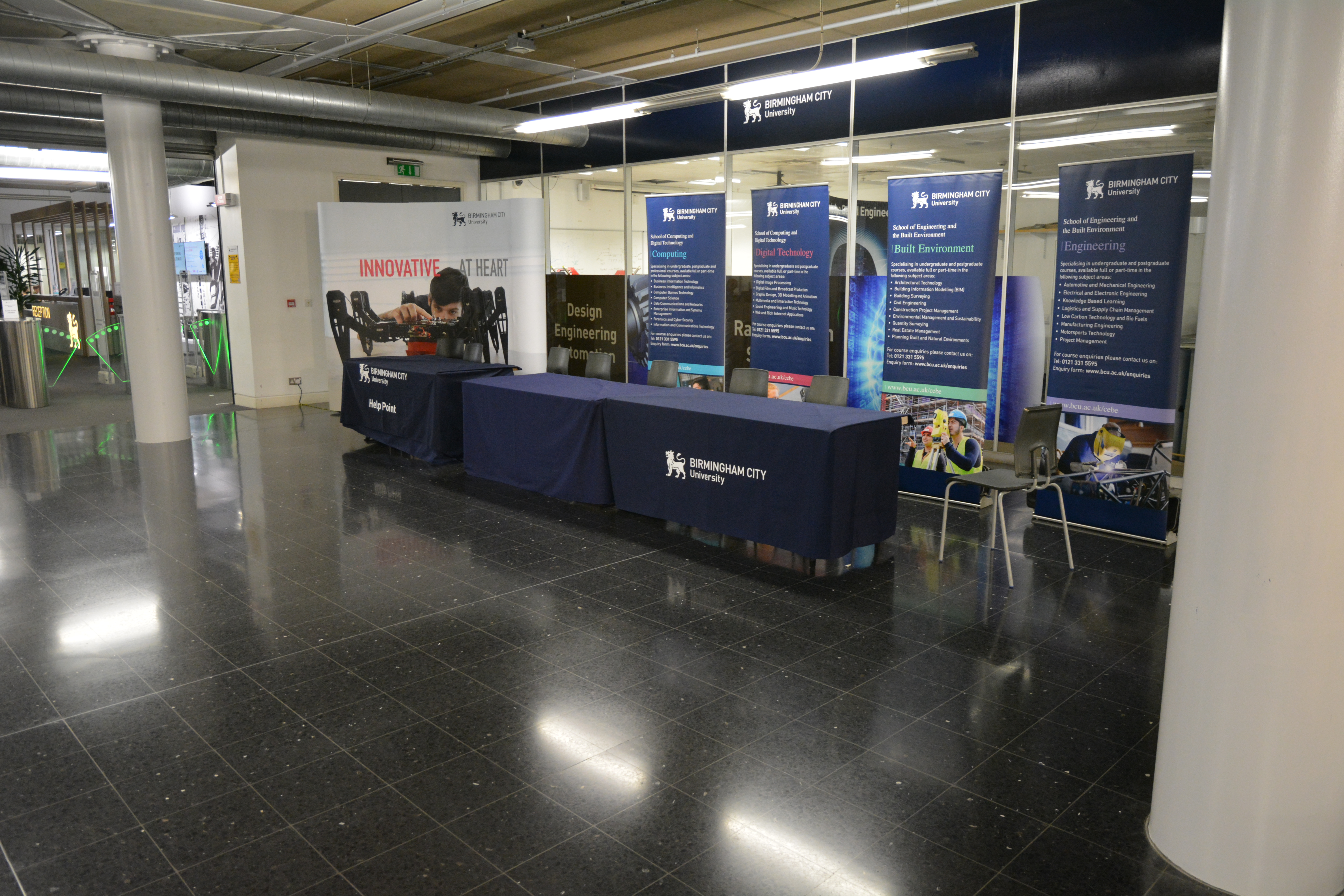 Millennium Point Concourse event space with registration area and promotional banners.