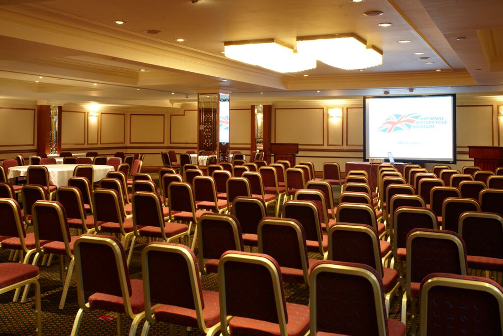 Conference room at The Bracebridge, featuring rows of chairs for seminars and workshops.