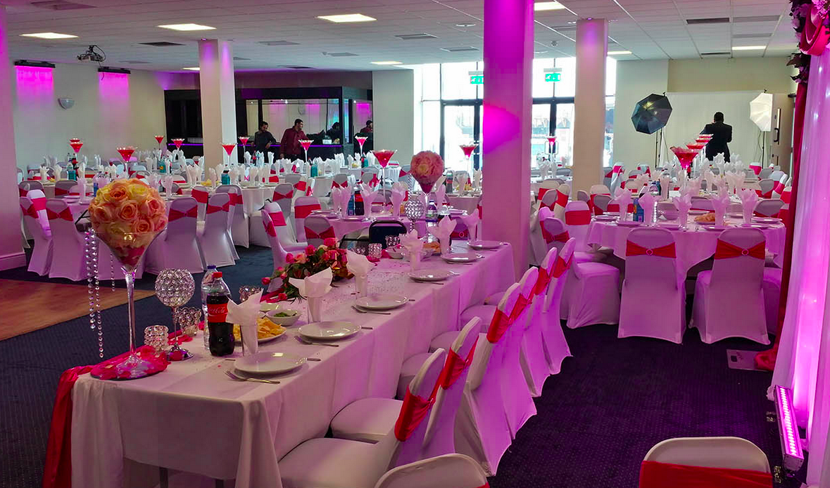 Elegant Saffron Suite event space with red accents, perfect for formal gatherings and celebrations.