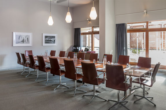 Modern Frobisher Boardroom with polished table, ideal for conferences and meetings.