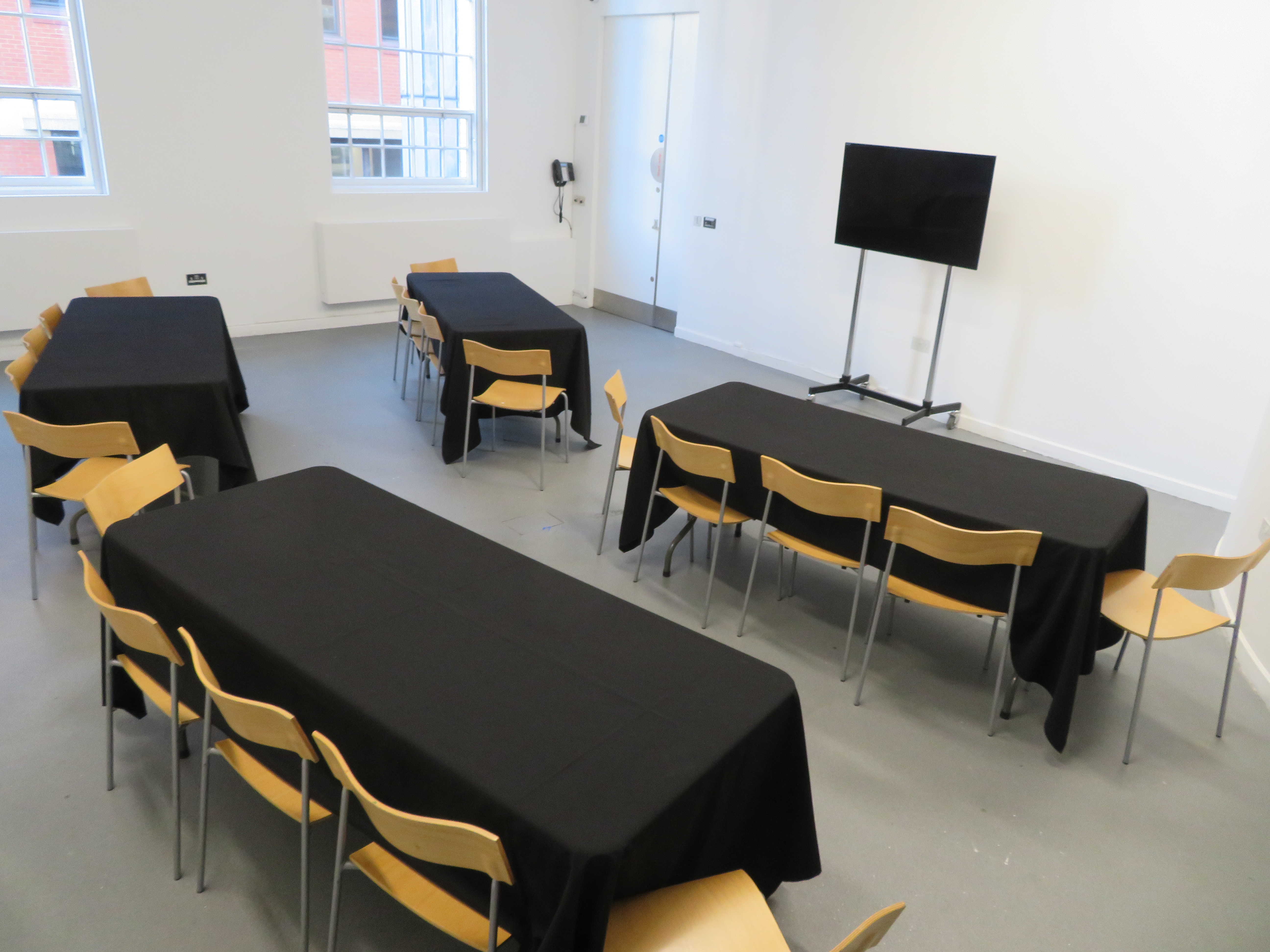 Versatile Ikon Gallery Events Room with black tablecloths for workshops and meetings.