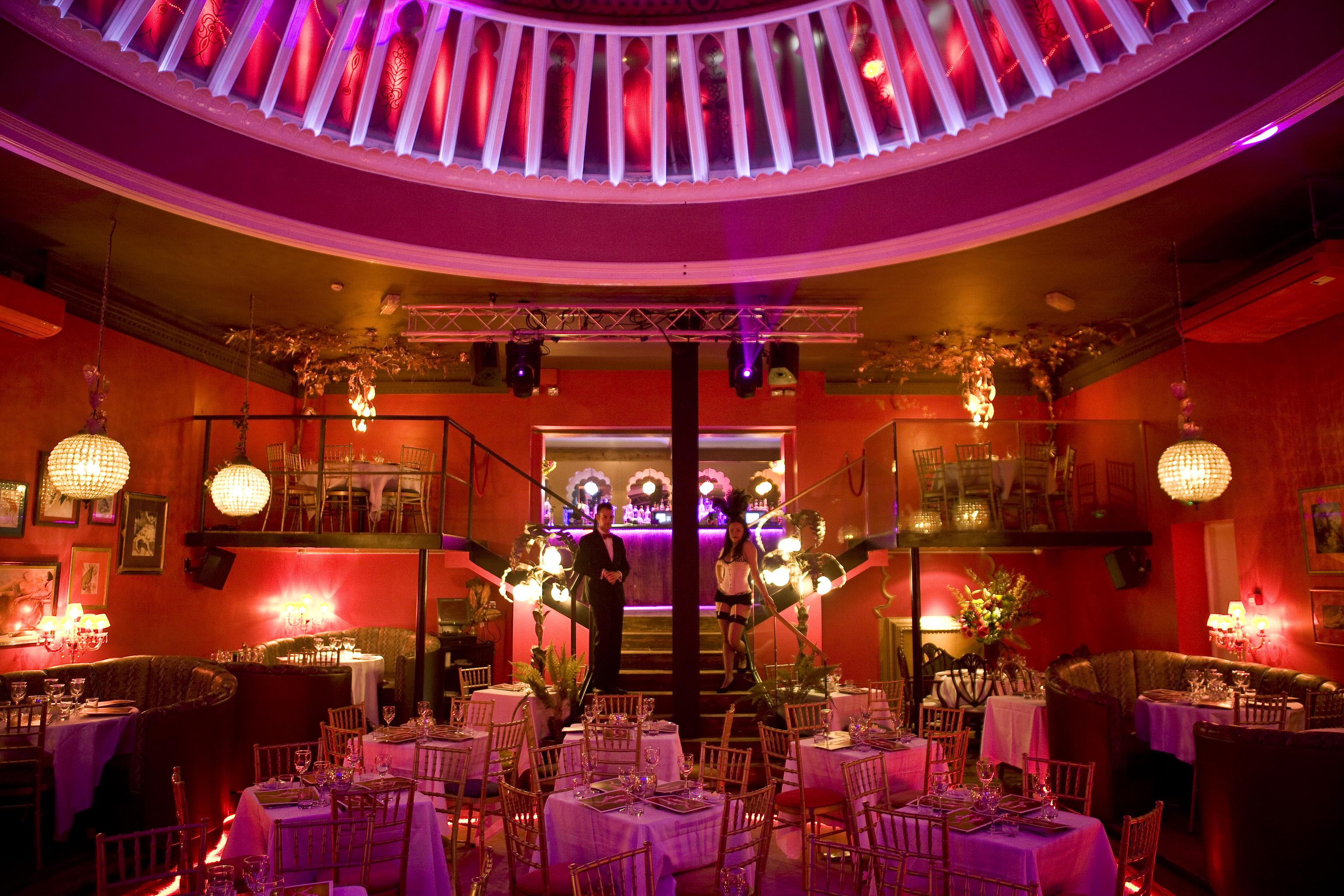 Elegant event space at Proud Cabaret Brighton with stylish tables and stage for gatherings.