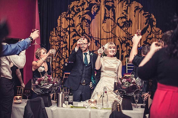 Wedding reception toast at Proud Cabaret Brighton with elegant decor and joyful ambiance.