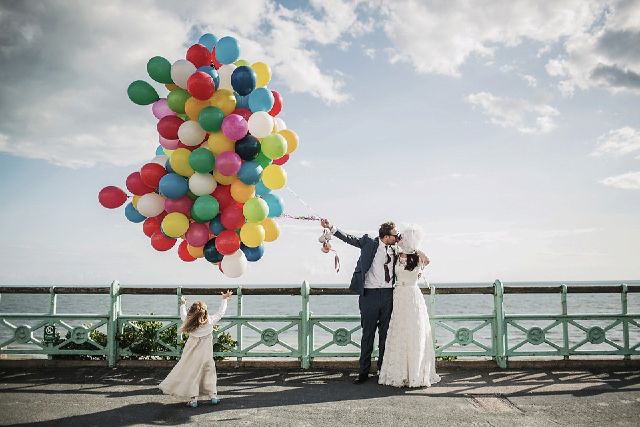 Joyful seaside wedding at Proud Cabaret Brighton with vibrant balloons and family fun.