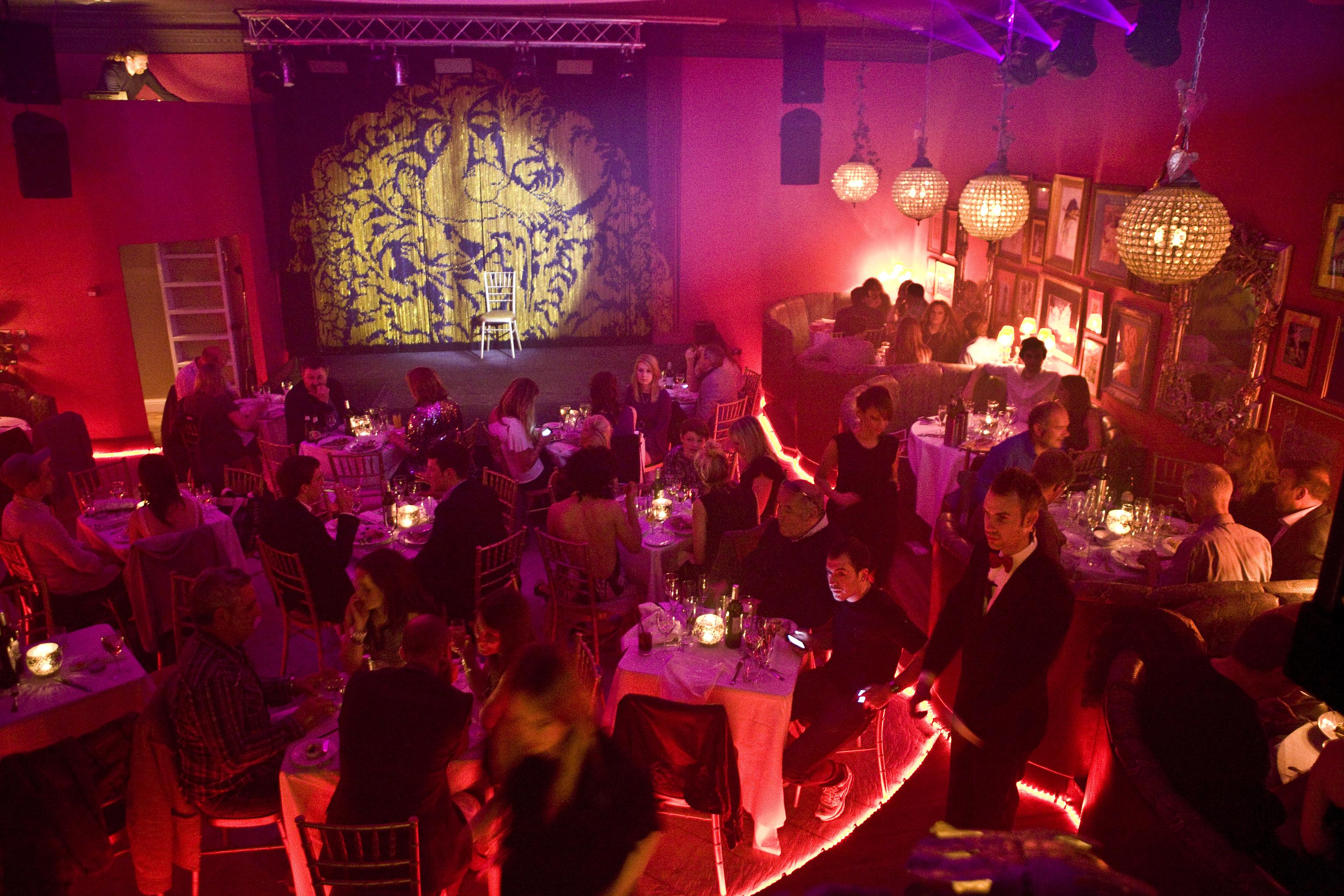 Intimate event space at Proud Cabaret Brighton with elegant tables and stage for live entertainment.