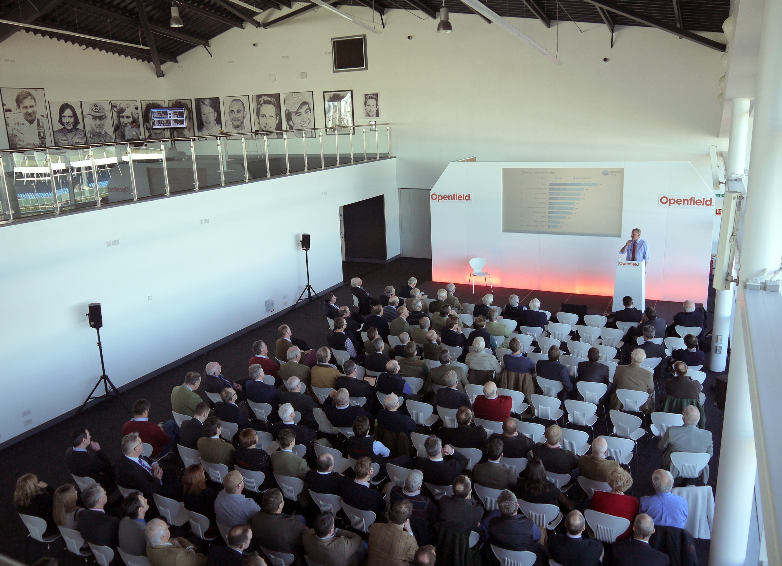 "Modern conference hall with speaker engaging audience at Silverstone Exhibition Centre."