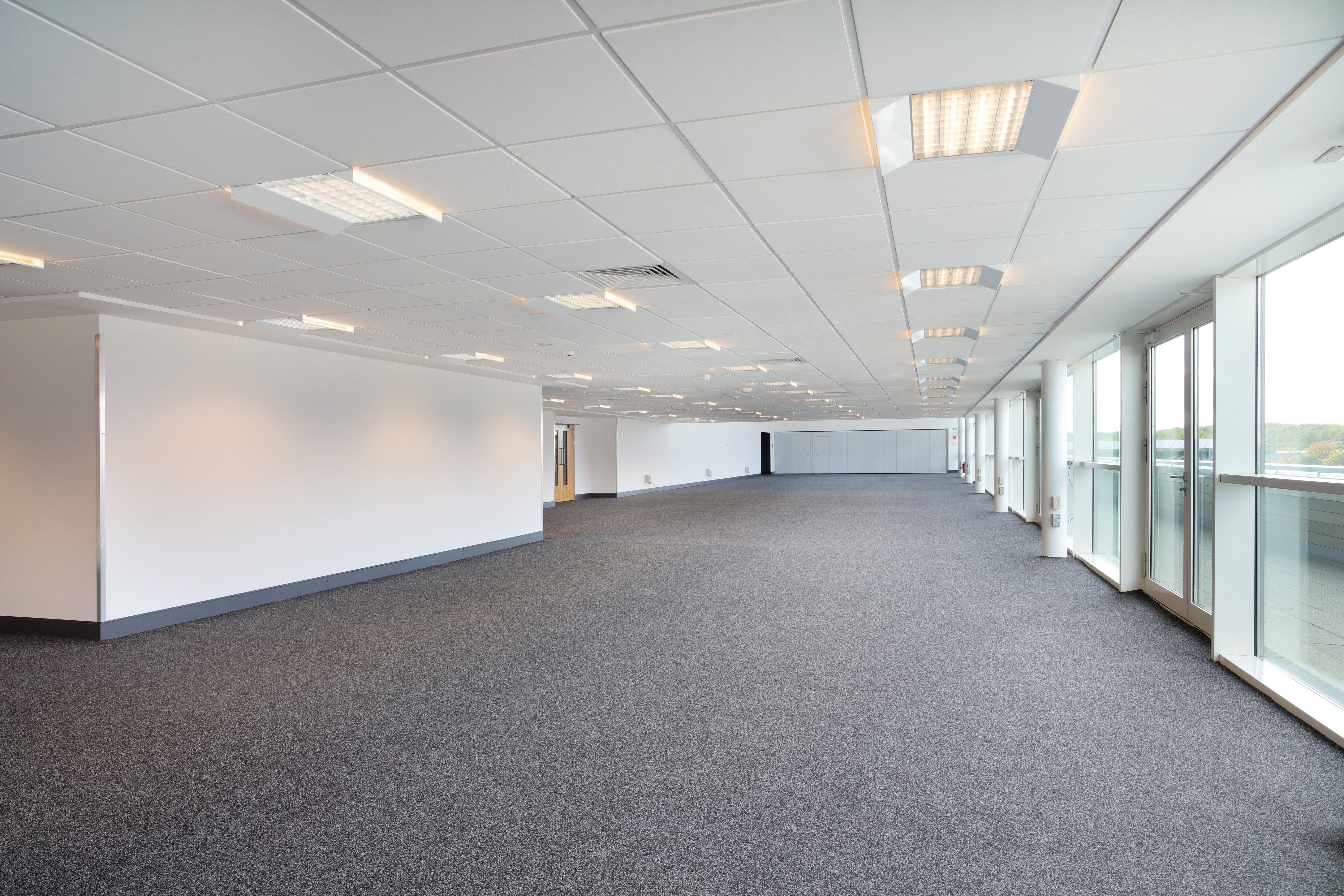 Spacious Hall 4 at Silverstone for corporate events, featuring large windows and modern design.