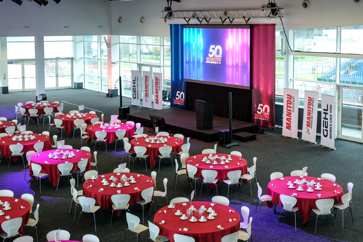 Hall 5 at Silverstone: elegant event space with red tables for formal gatherings.