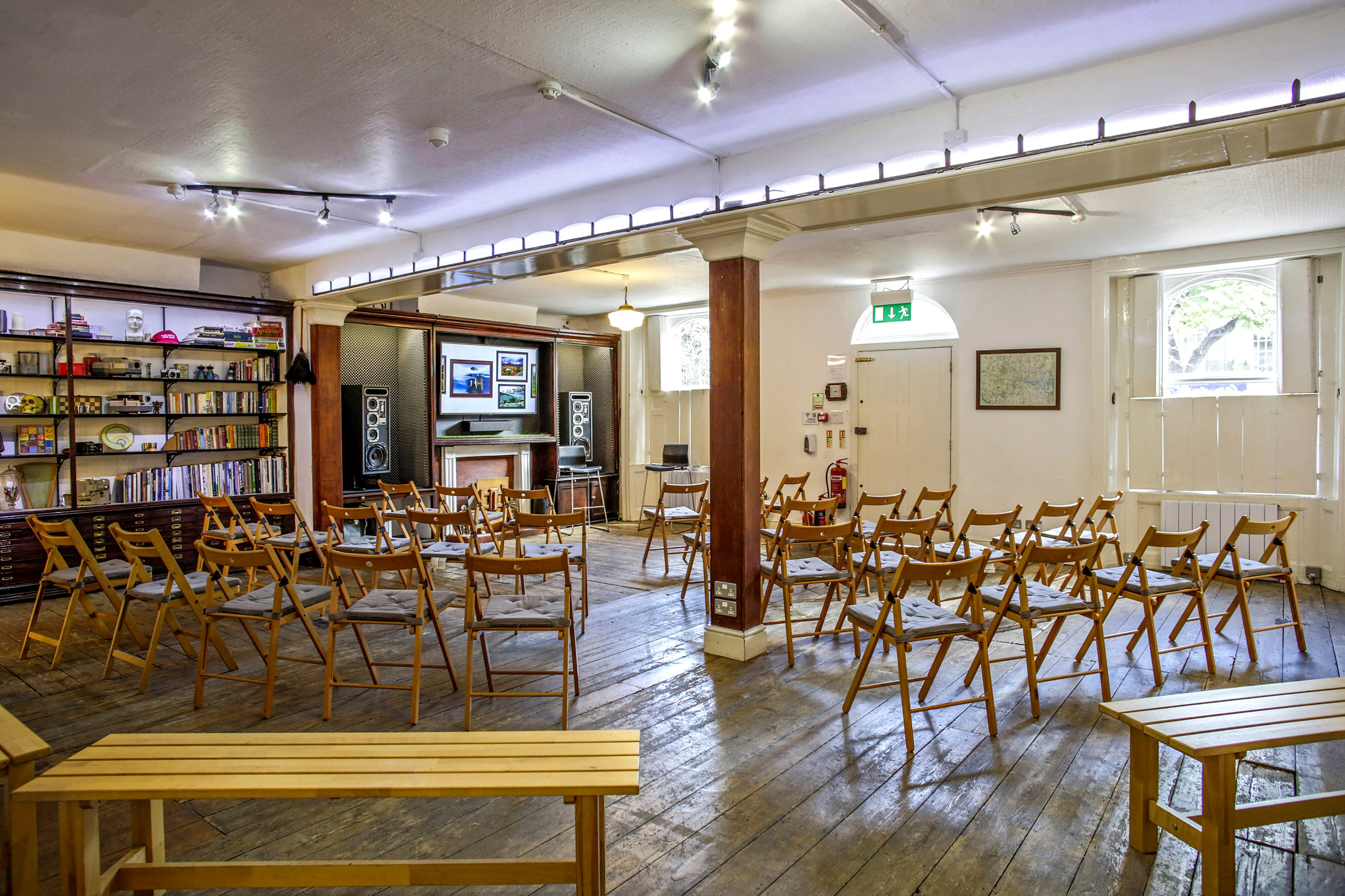 Versatile event space with wooden chairs for meetings and workshops in Anomalous Space.
