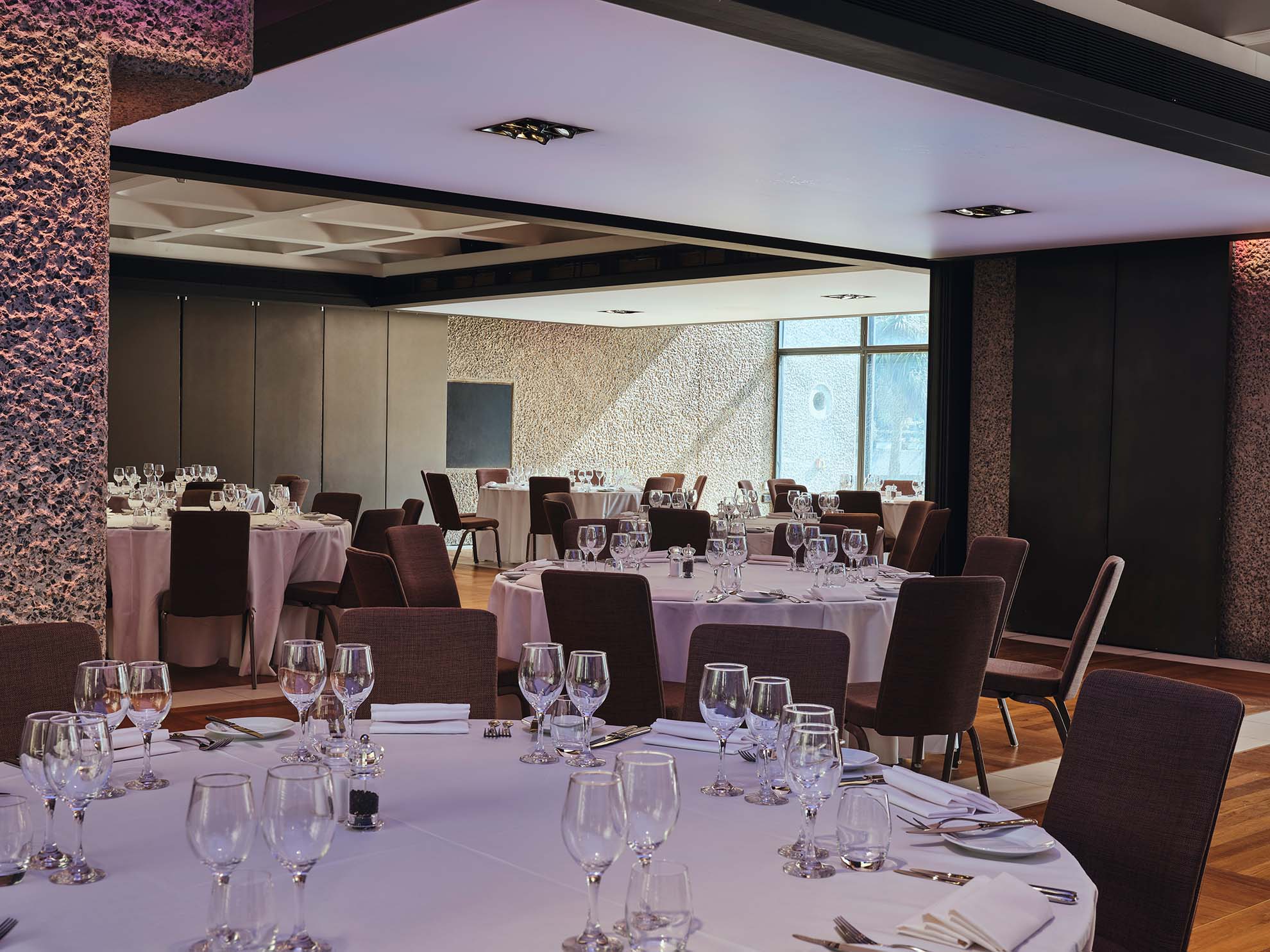Elegant event space at Barbican Centre with round tables for corporate meetings.