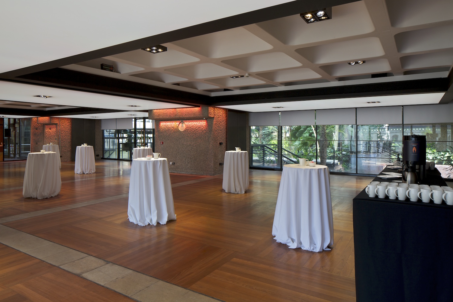 Elegant event space in Barbican Centre with high-top tables for networking and receptions.