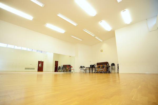Spacious dance studio in Oxford House with polished wooden floors for versatile events.