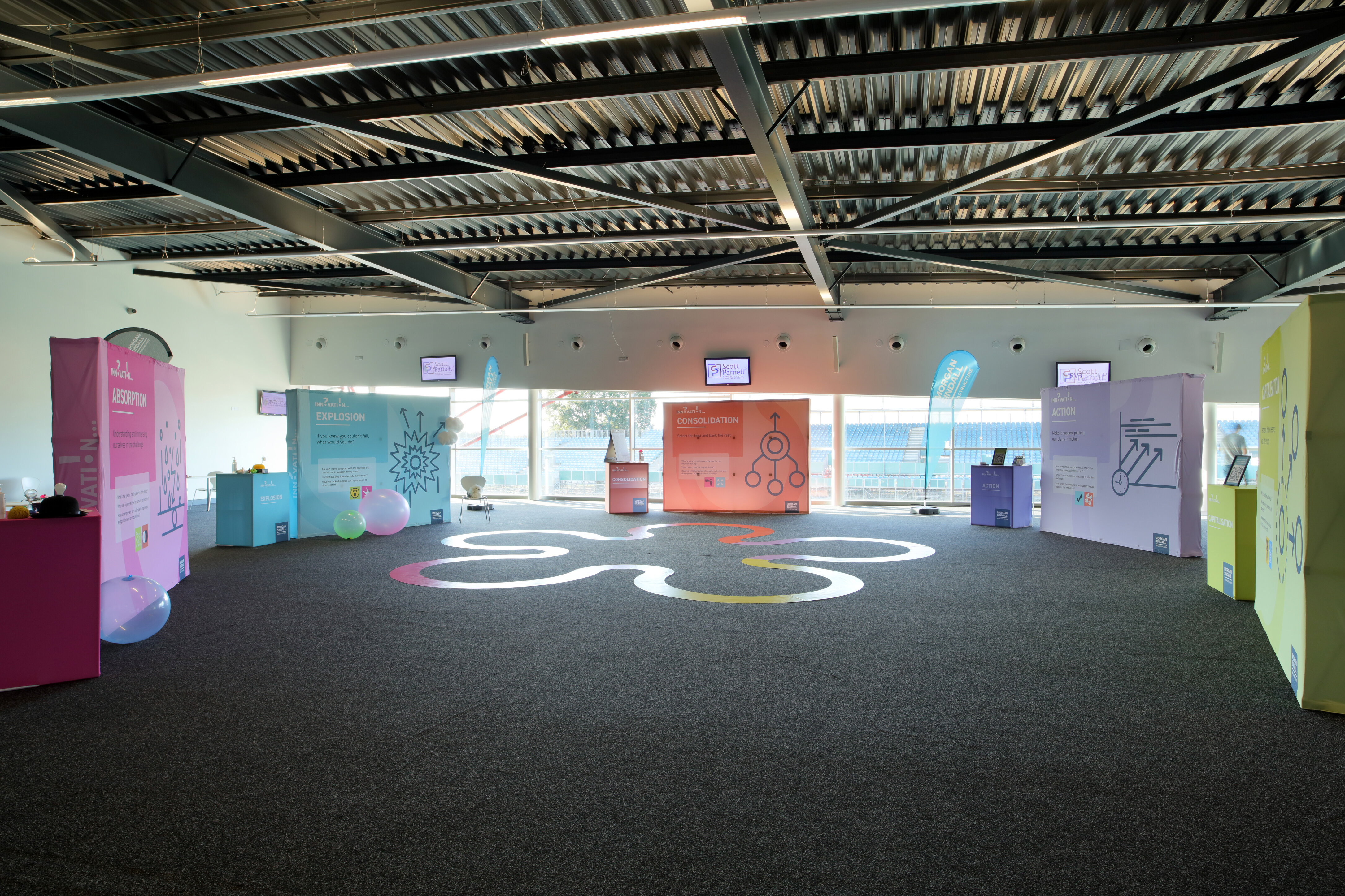 Spacious Silverstone conference hall with vibrant displays for exhibitions and networking events.