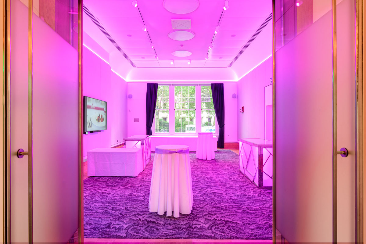 Sir Kirby Laing in modern event space with purple lighting for networking and receptions.