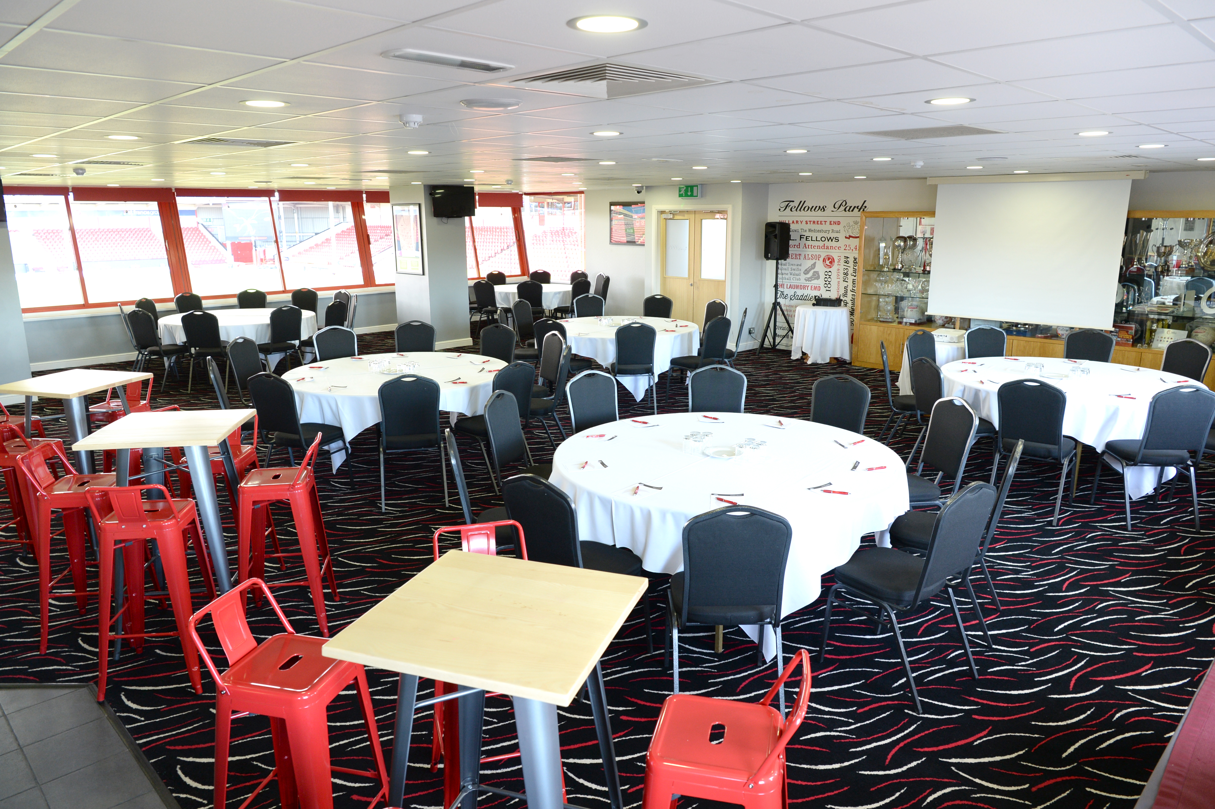 1888 Lounge at Walsall FC, elegant meeting space with round tables for events.