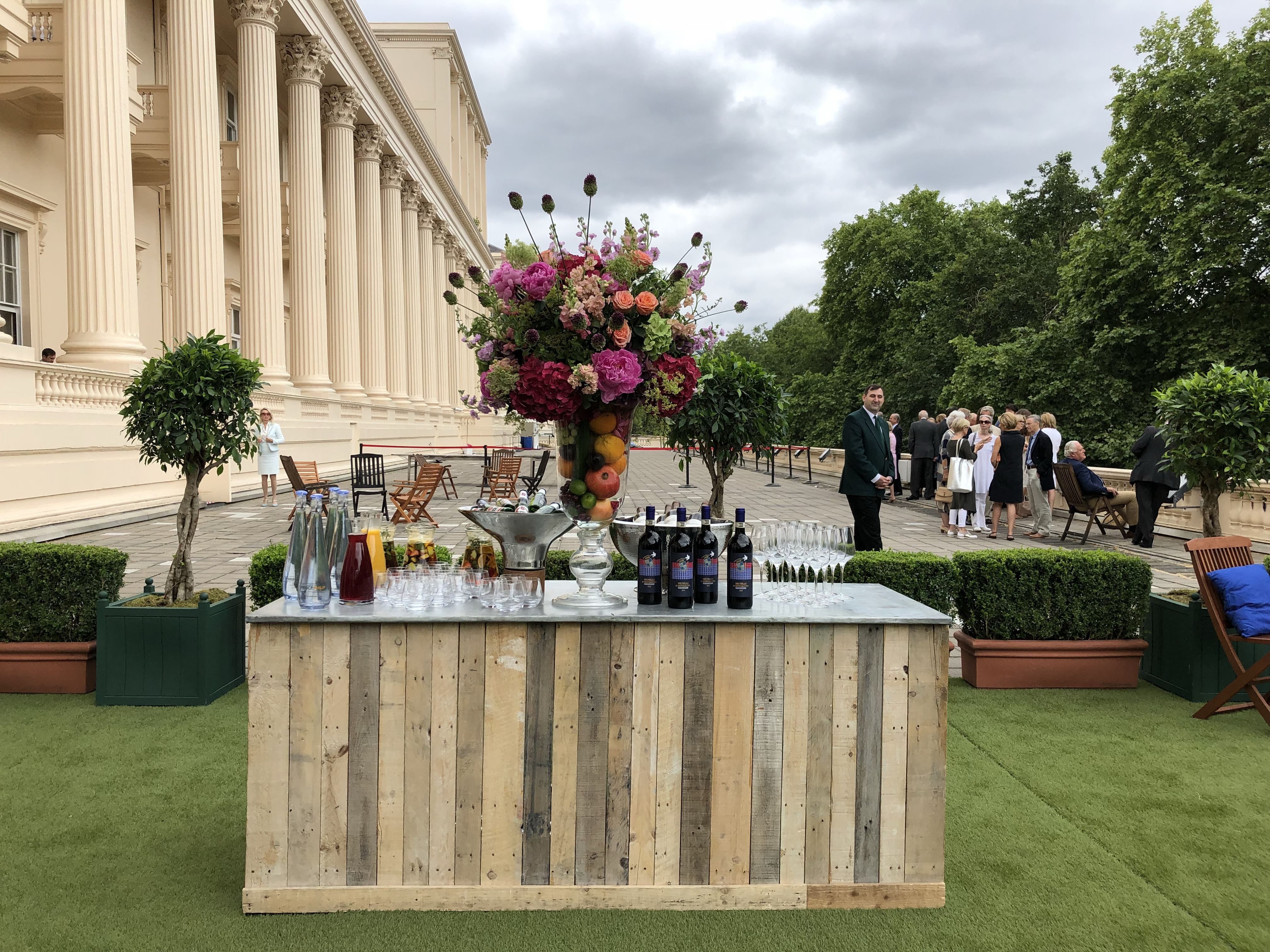 Elegant outdoor event at Prince Philip House with floral centerpiece and classic architecture.