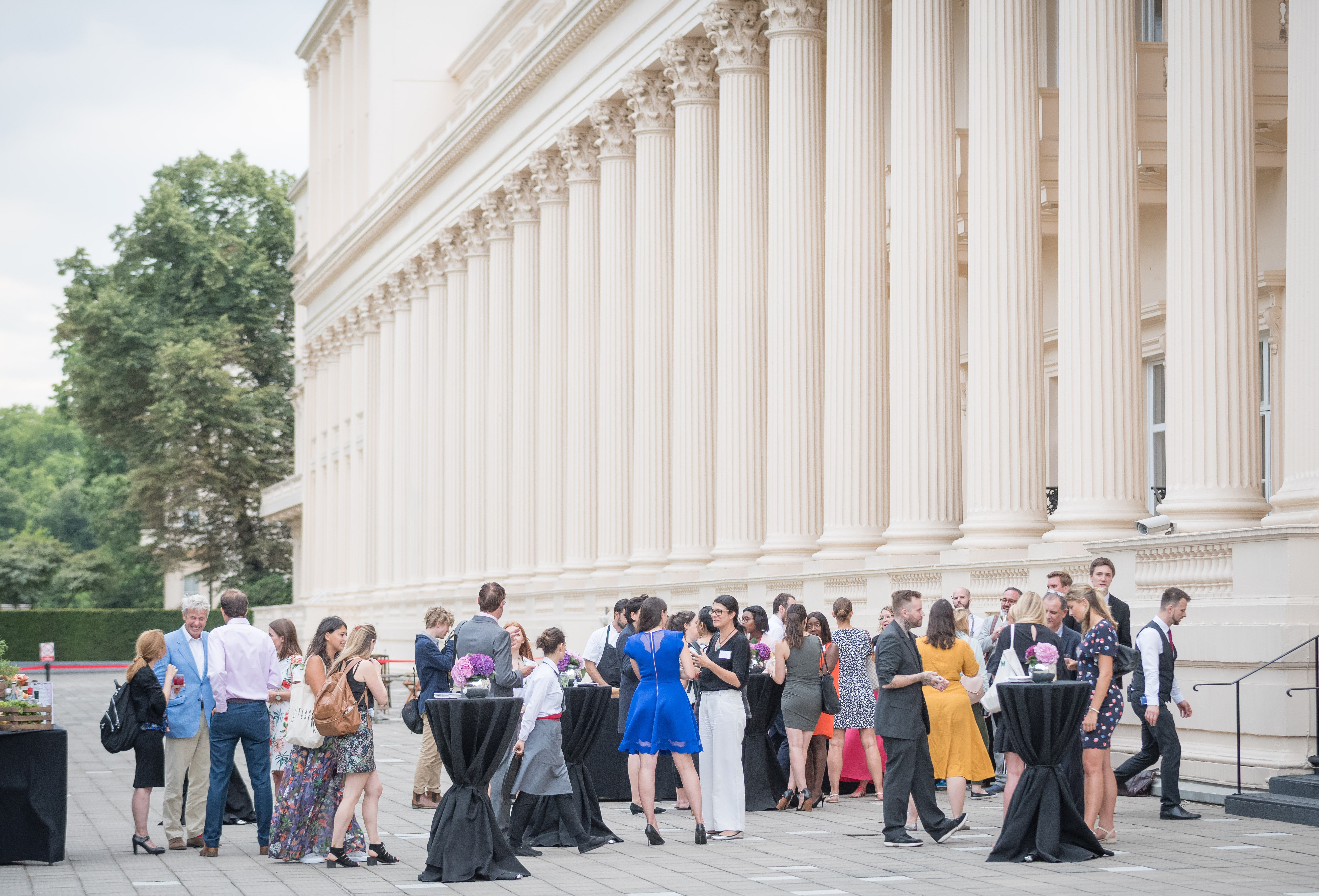Vibrant outdoor networking event at Prince Philip House with elegant architecture.