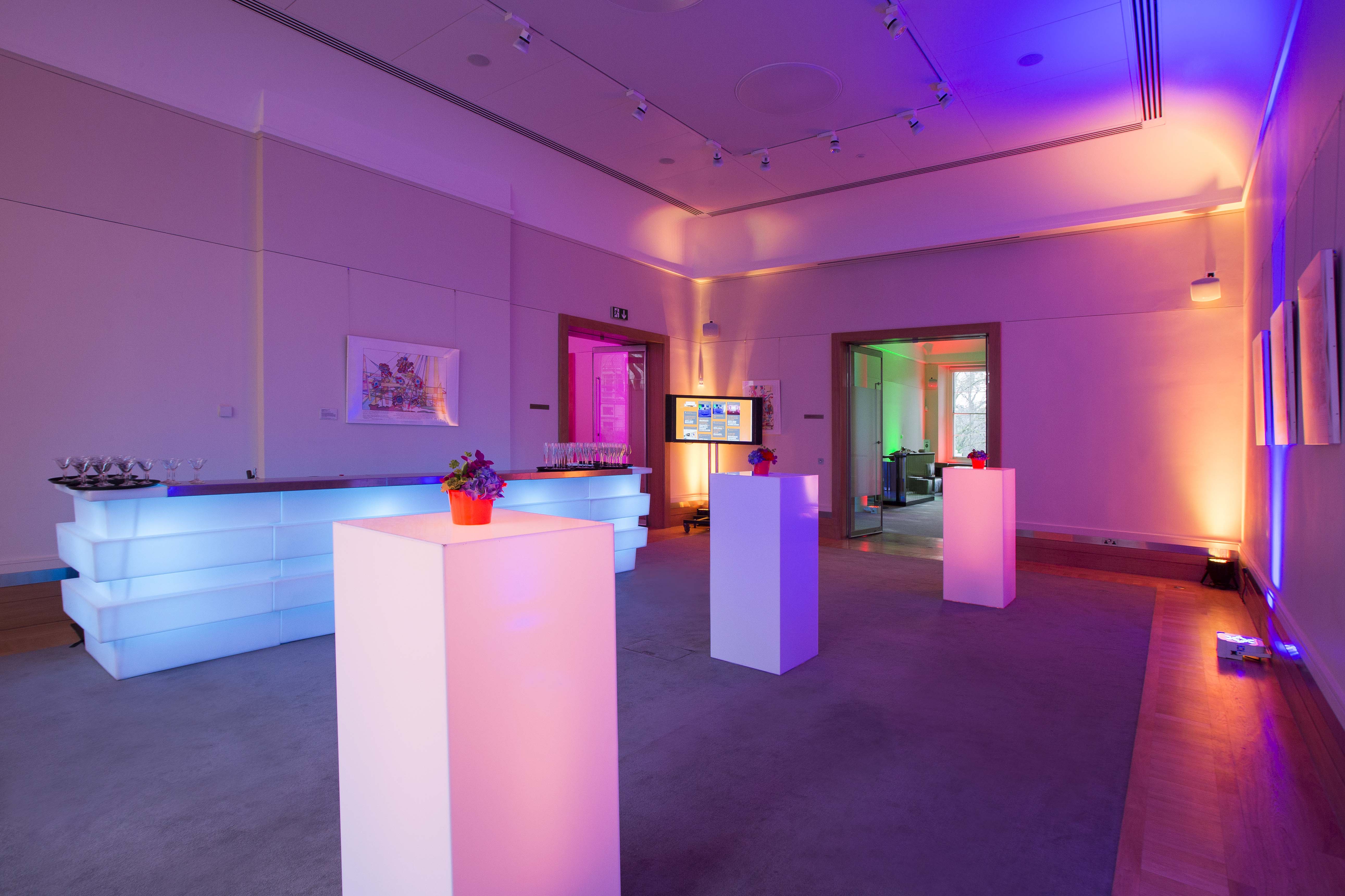 David Sainsbury at Prince Philip House, modern event space with illuminated pedestals.