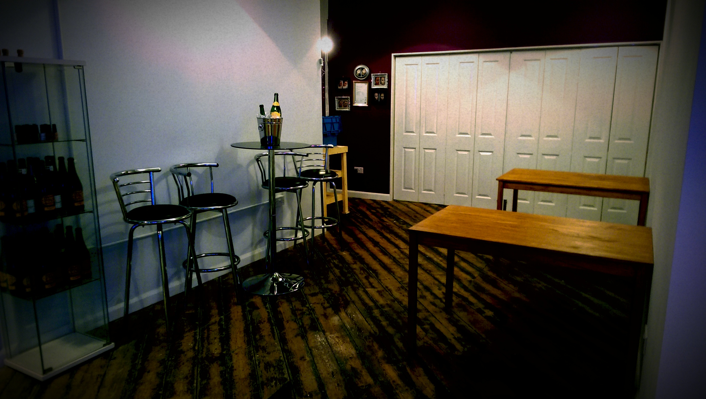 Minimalist event space with bar setup, ideal for networking and workshops at 47 Dale Street.