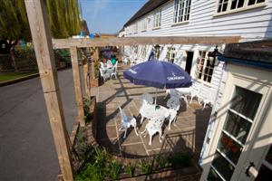 Shires outdoor patio with white furniture, ideal for casual meetings and events.