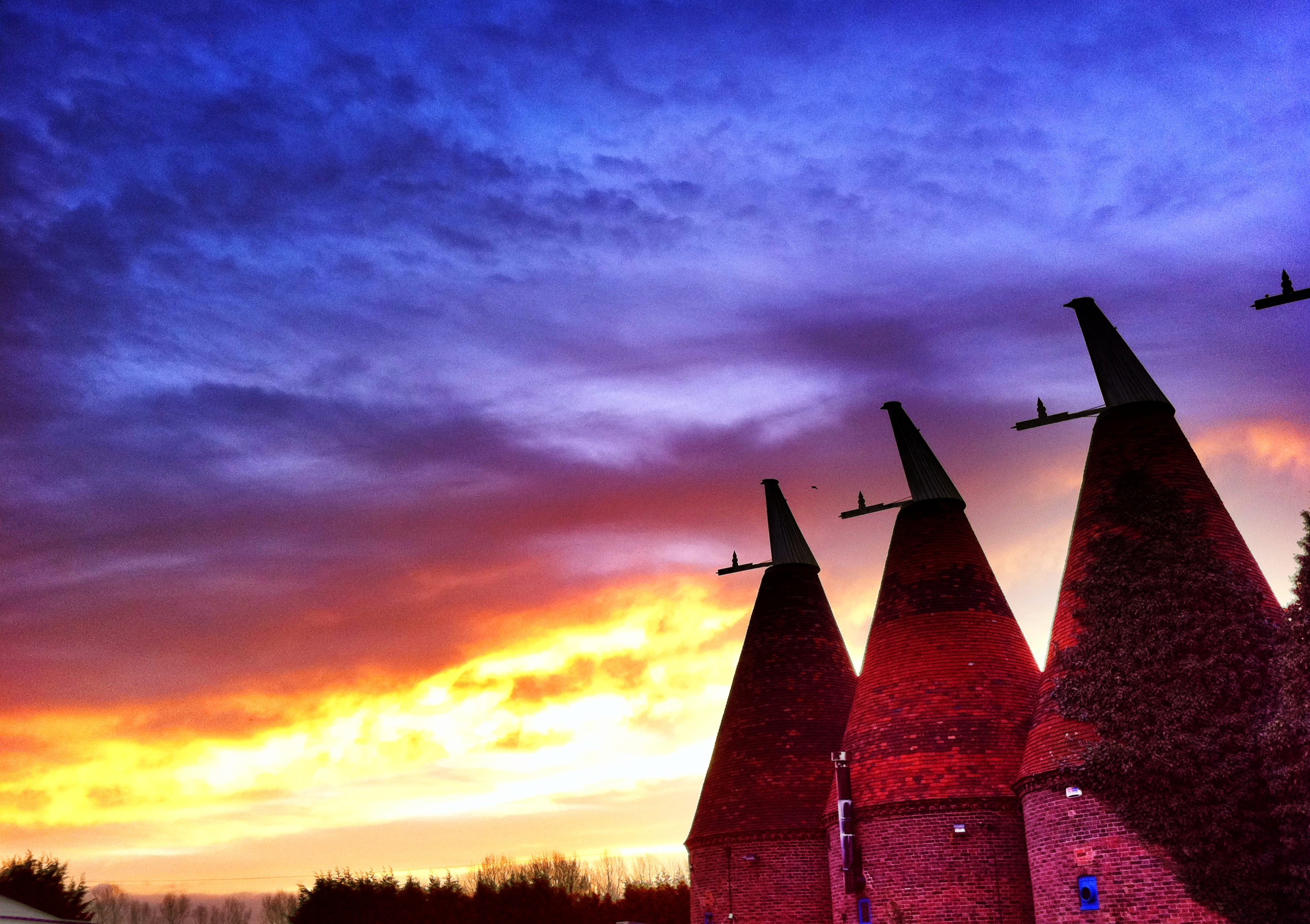 Dray Marquee at Hop Farm with conical structures, perfect for sunset events and receptions.