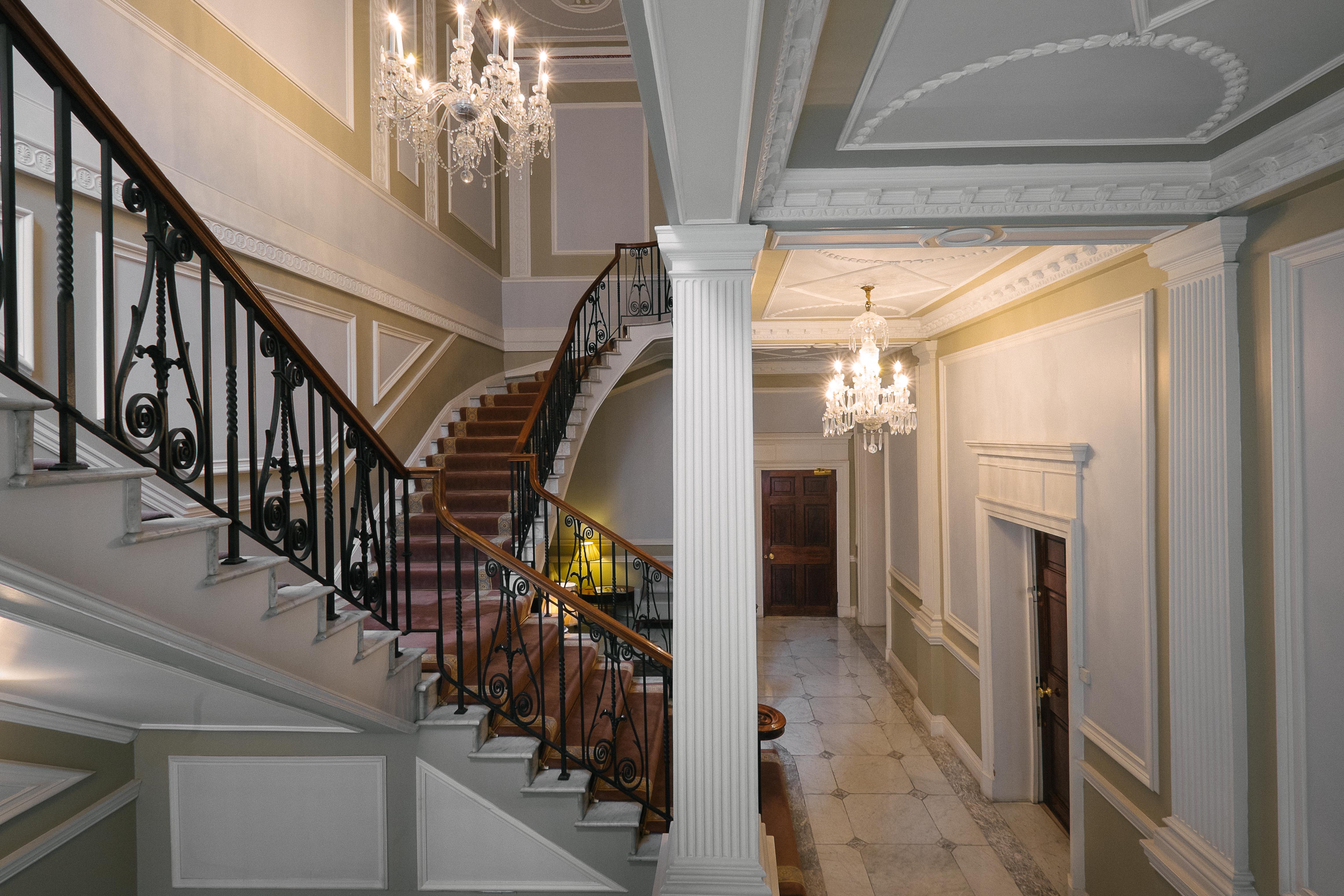 Elegant foyer with grand staircase at Fleming GreenSpace, ideal for upscale events and meetings.