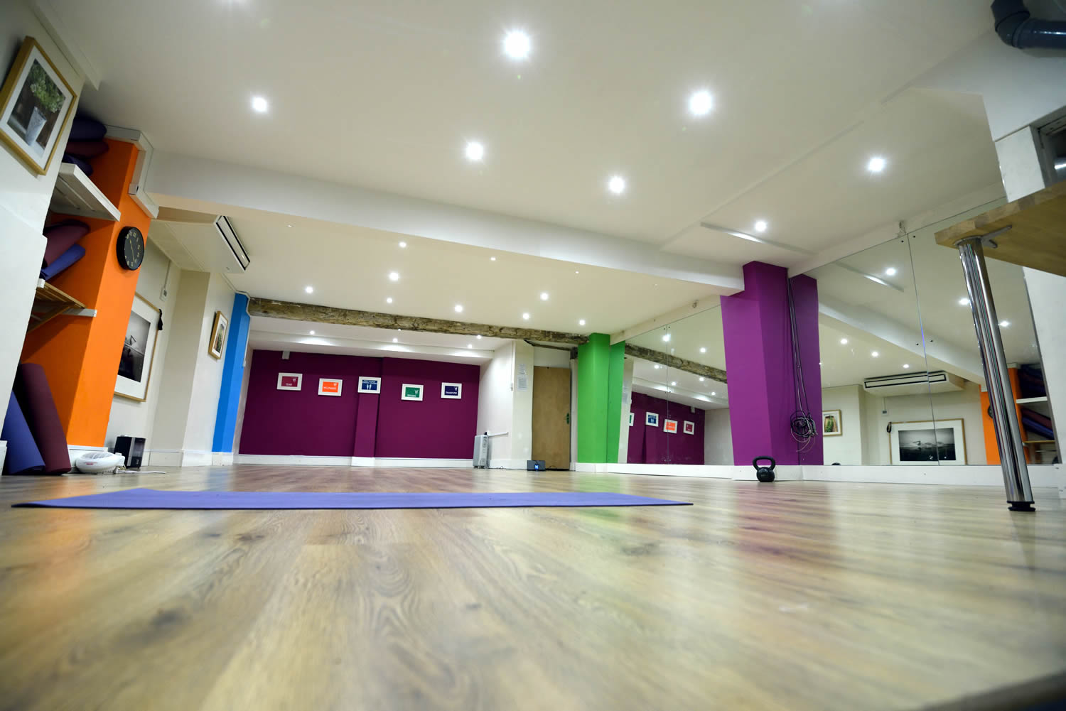 Versatile event space with vibrant walls, ideal for workshops and fitness classes.
