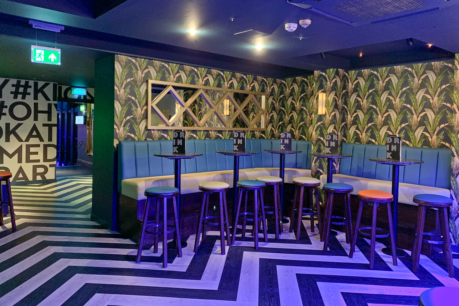 Vibrant Studio 61 event space with tropical backdrop, perfect for networking and gatherings.