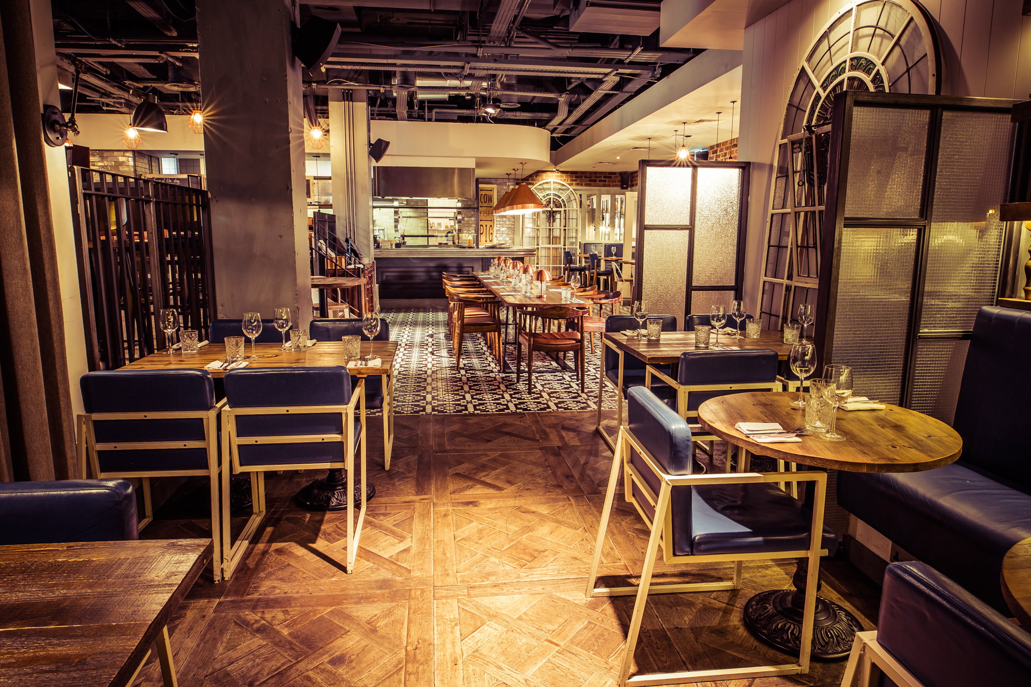 Modern restaurant dining space with wooden furniture, ideal for events and intimate gatherings.