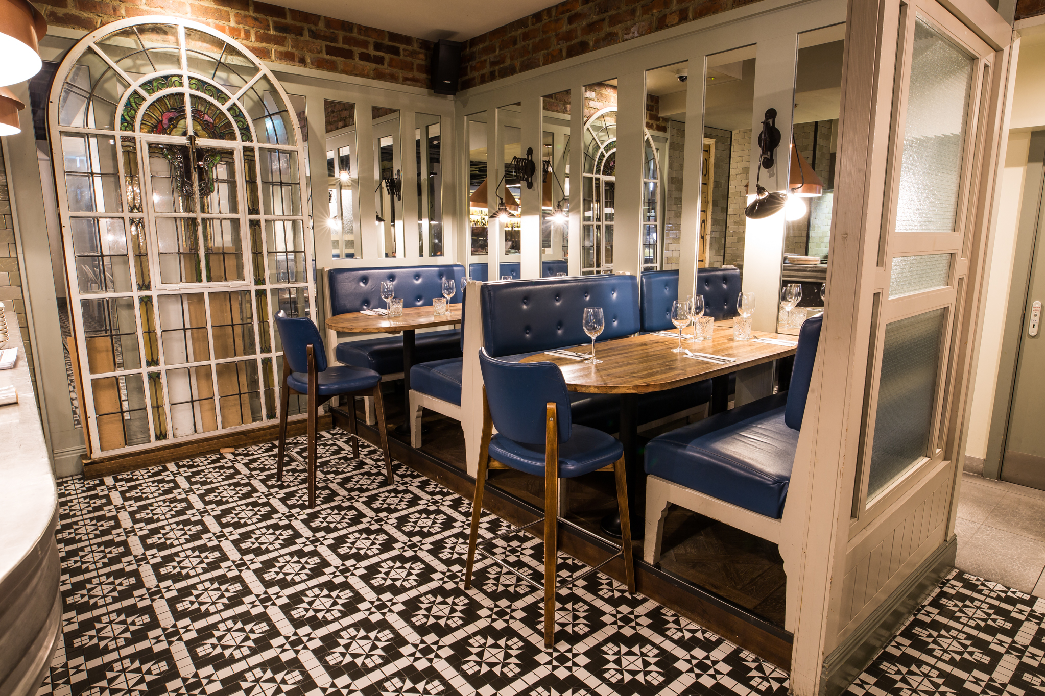 Stylish restaurant dining area with blue seating, perfect for intimate events.
