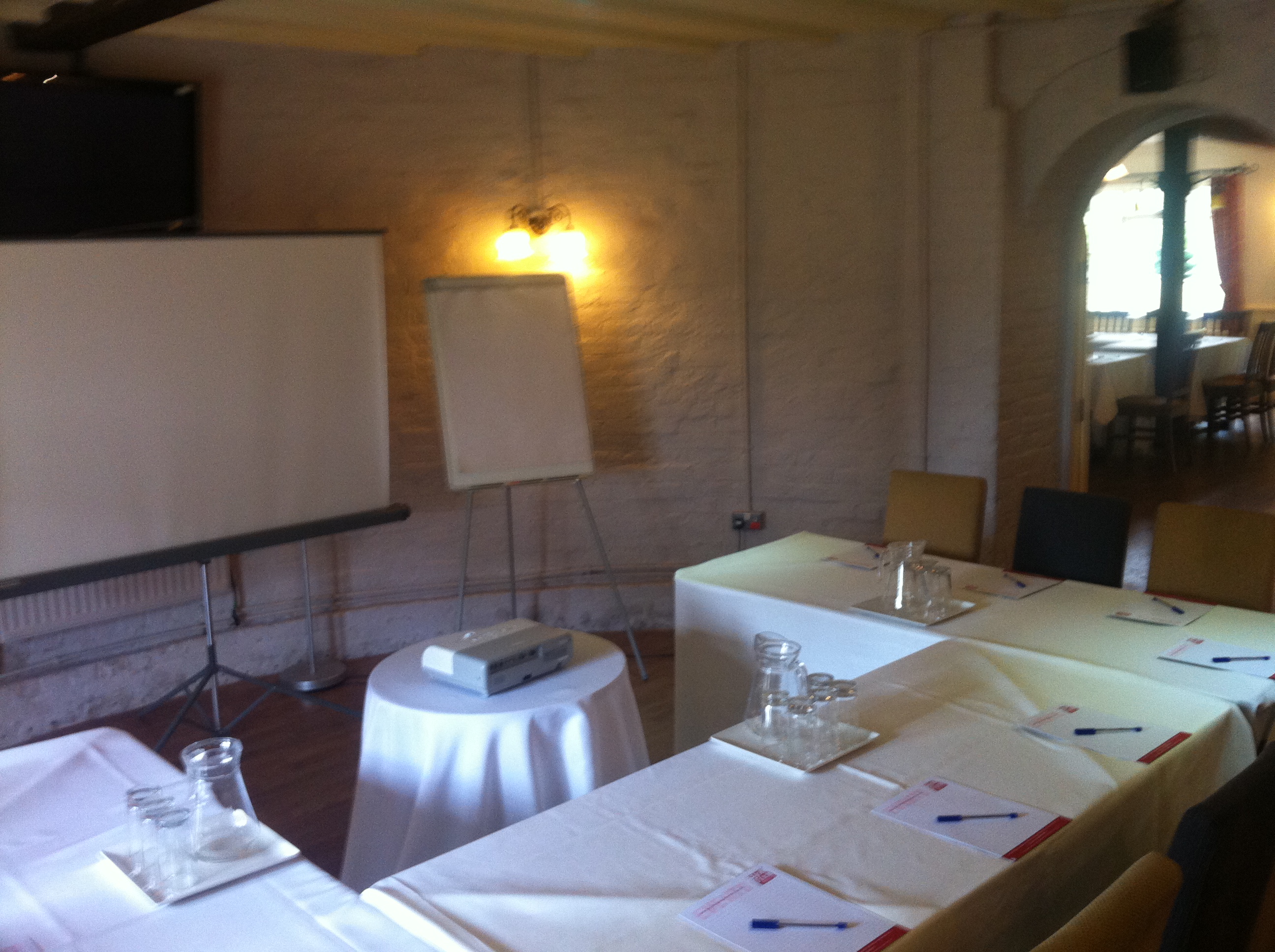 Meeting space at The Roundels, featuring projector and inviting lighting for workshops.