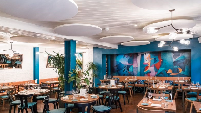 Vibrant Lima Cantina dining room with round tables for stylish events and meetings.