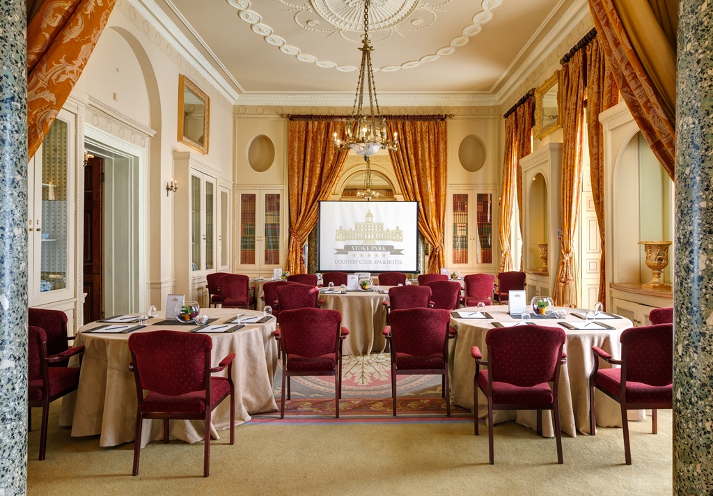 Function room at Stoke Park with elegant decor, ideal for meetings and workshops.