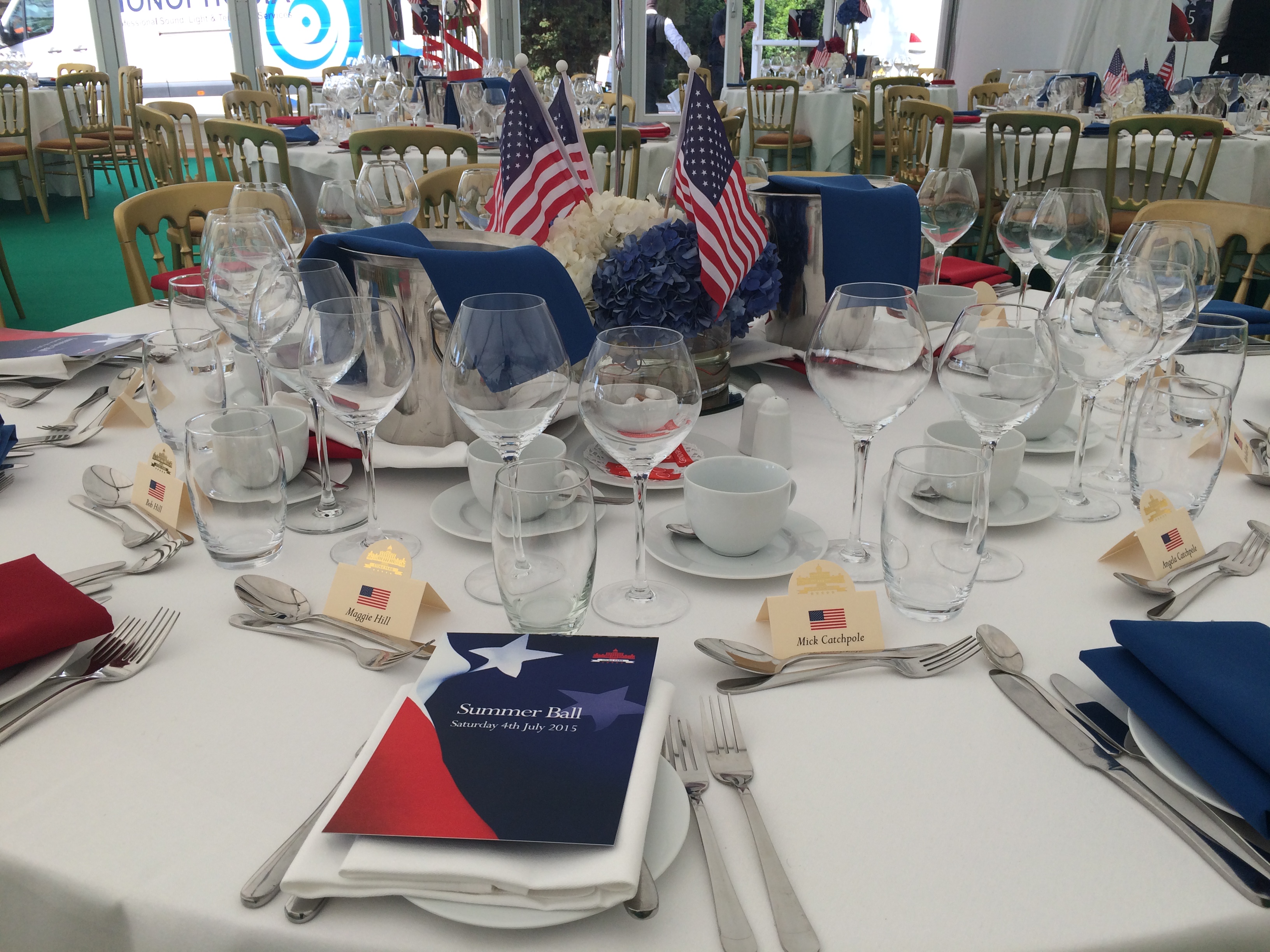 Function room banquet table with red, white, and blue decor for a summer ball event.