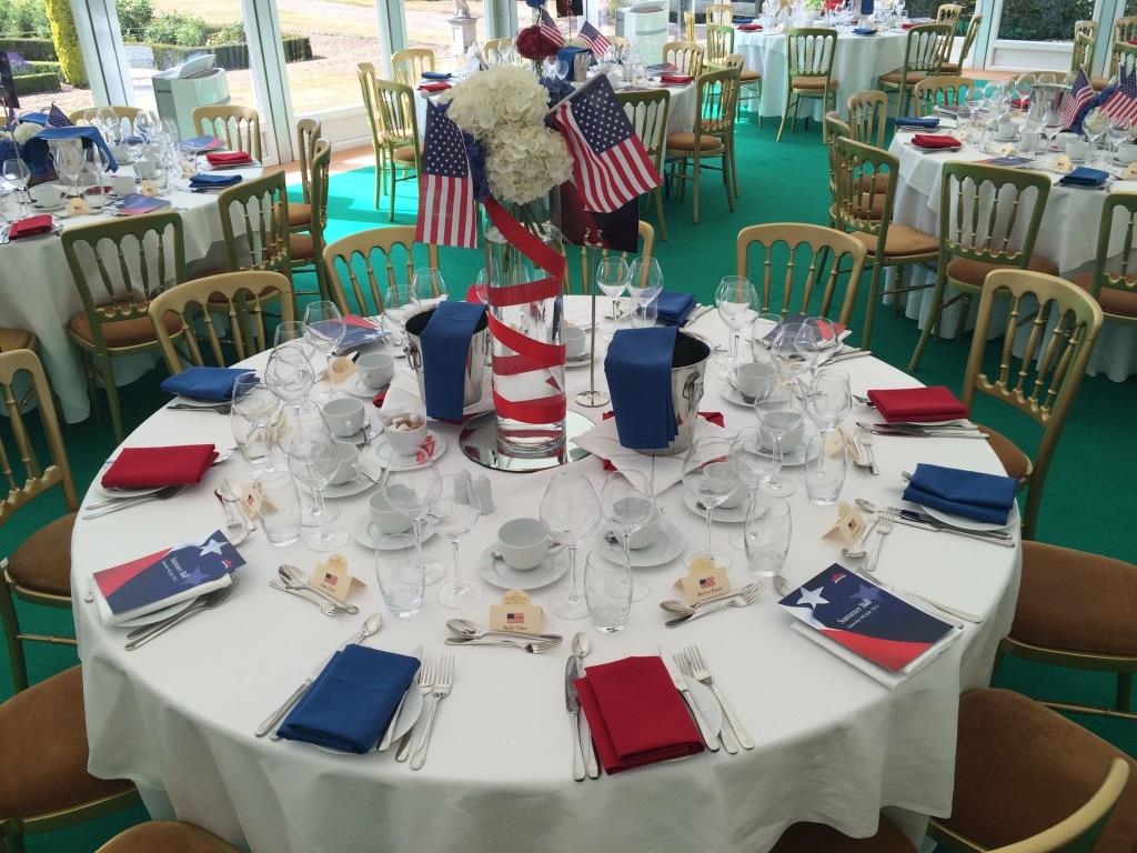 Function room banquet table with red, white, and blue decor for corporate events.