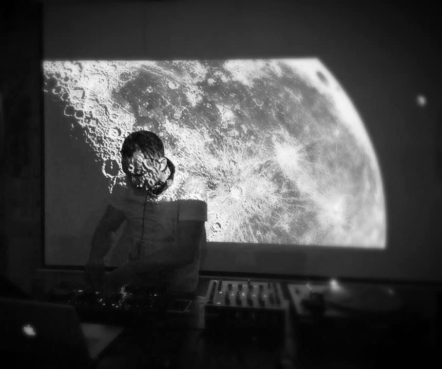 DJ performance at Centrala Gallery with moon backdrop for immersive event experience.