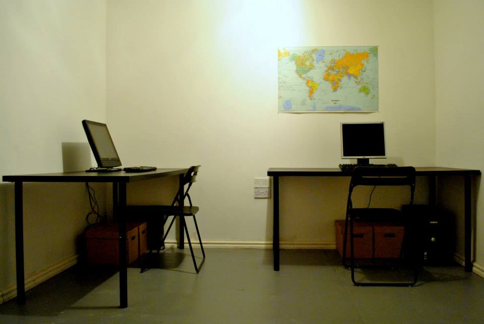 Minimalist meeting space with desks, ideal for team collaborations and virtual meetings.