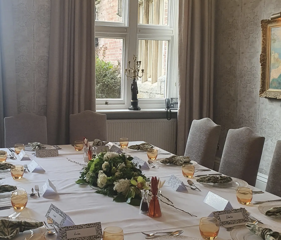Churchill Suite meeting room with floral centerpieces for elegant events at Alexander House.