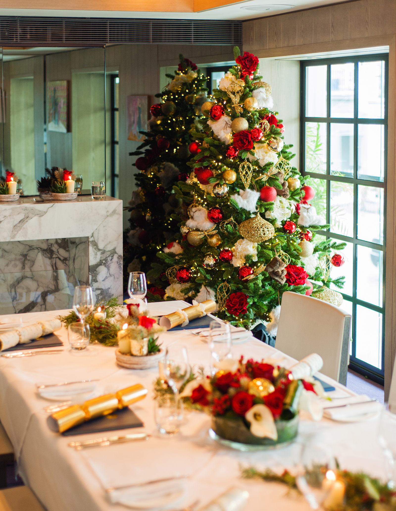 Elegant dining setup for Christmas parties at The Hari with a stunning tree.