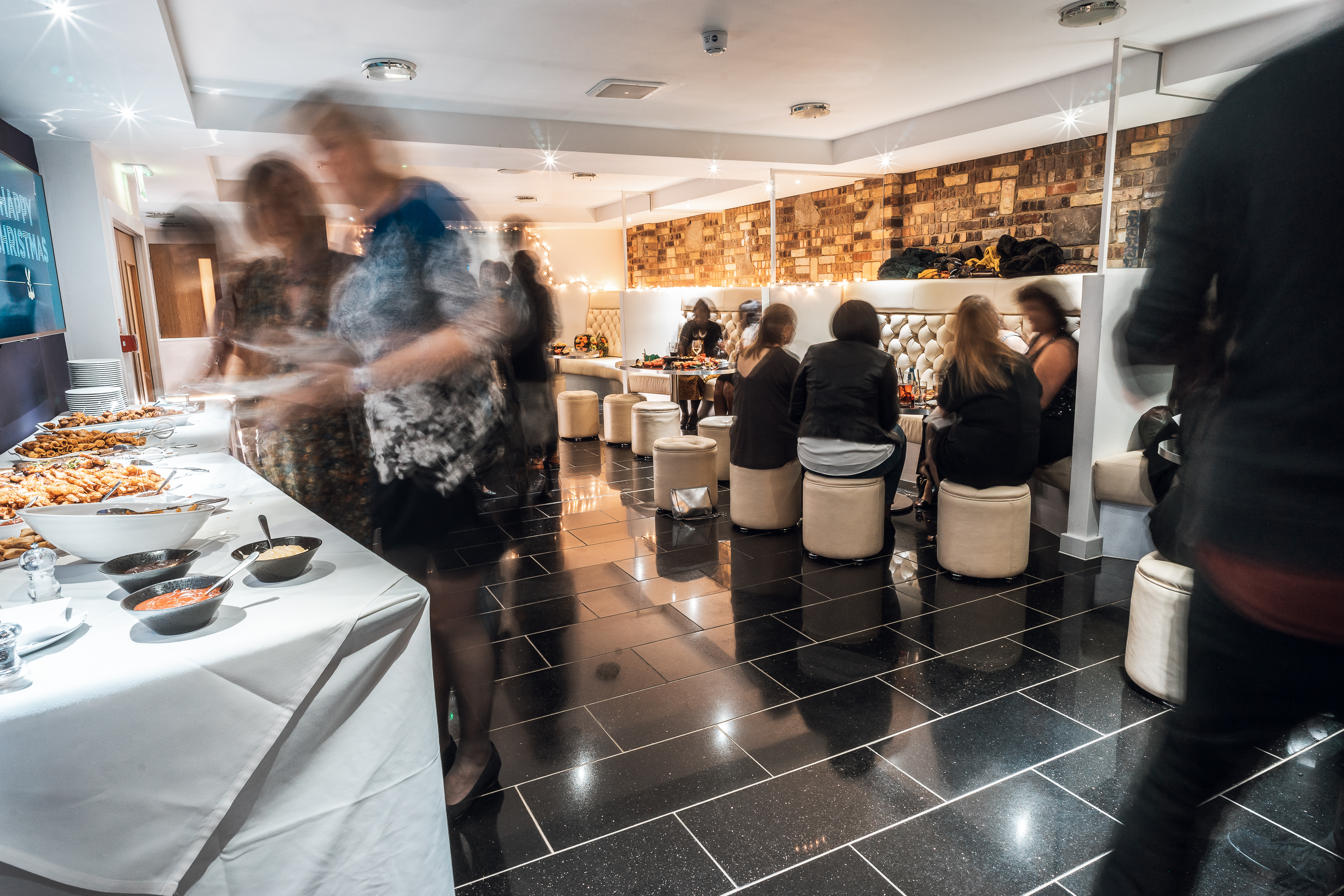 Vibrant 2010 Club event space at Selhurst Park with buffet setup and stylish seating.
