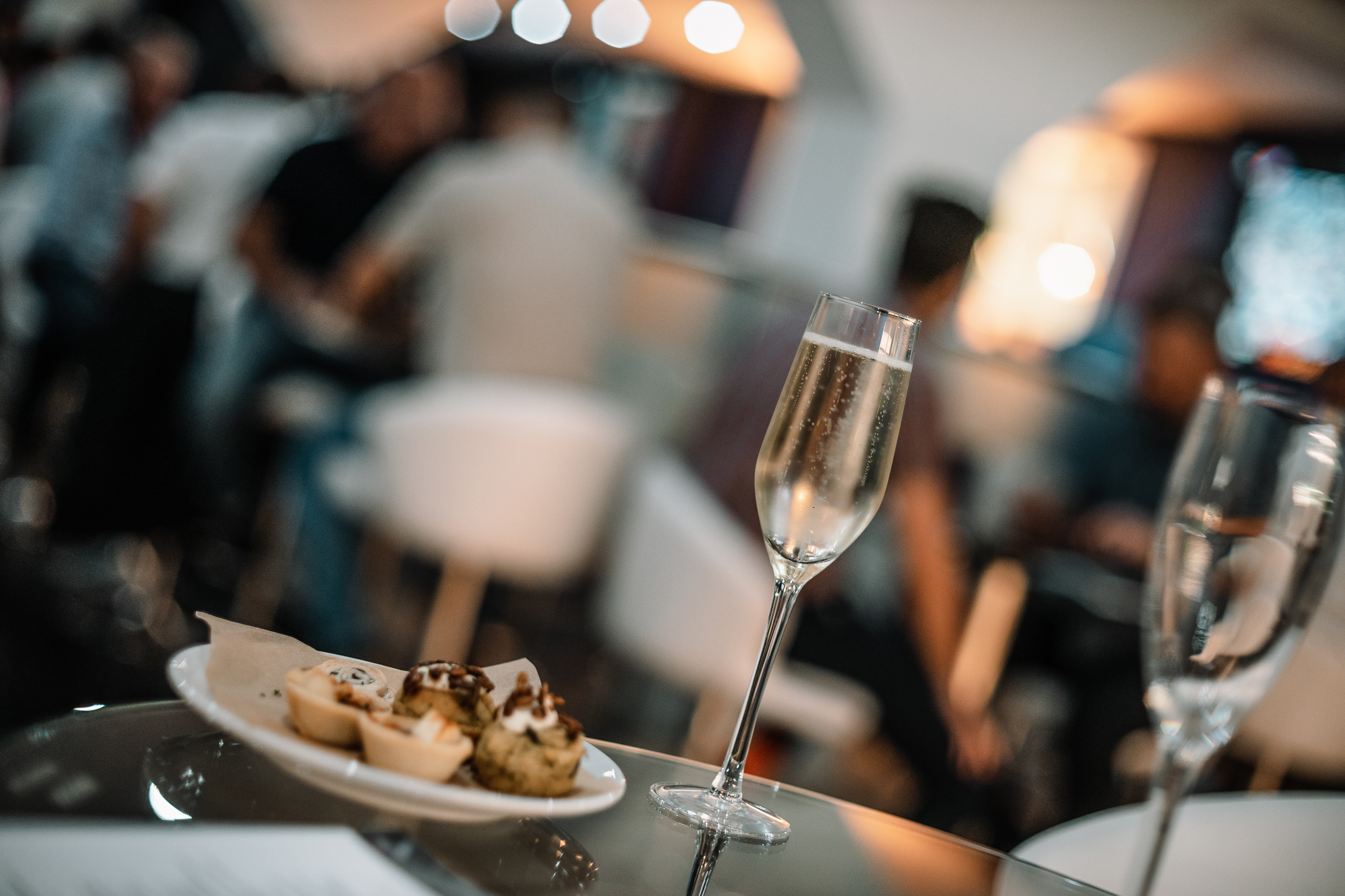 Elegant networking event at Crystal Palace with champagne and gourmet food.