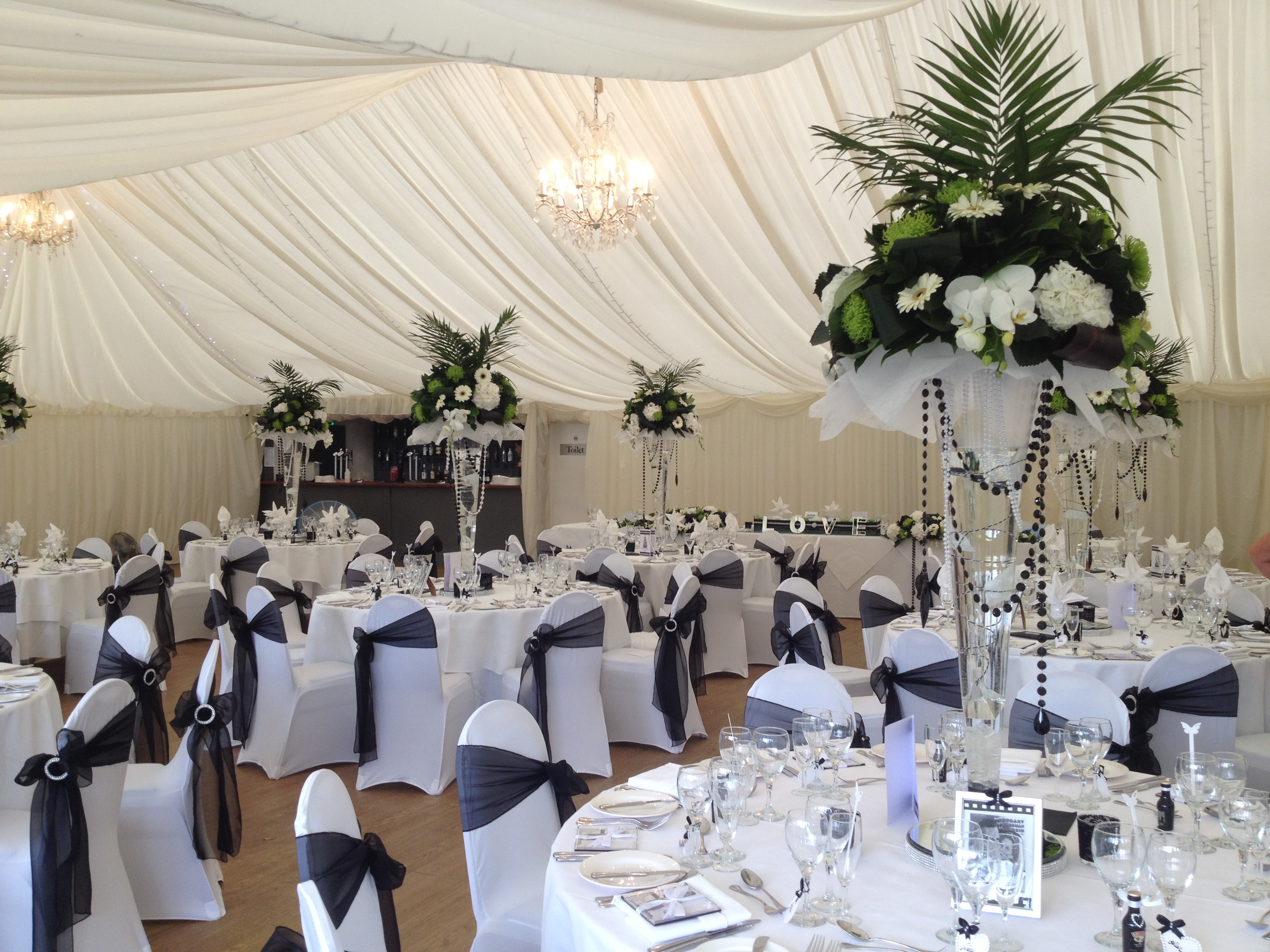 Elegant event space at Quendon Hall with floral centerpieces for weddings and gatherings.